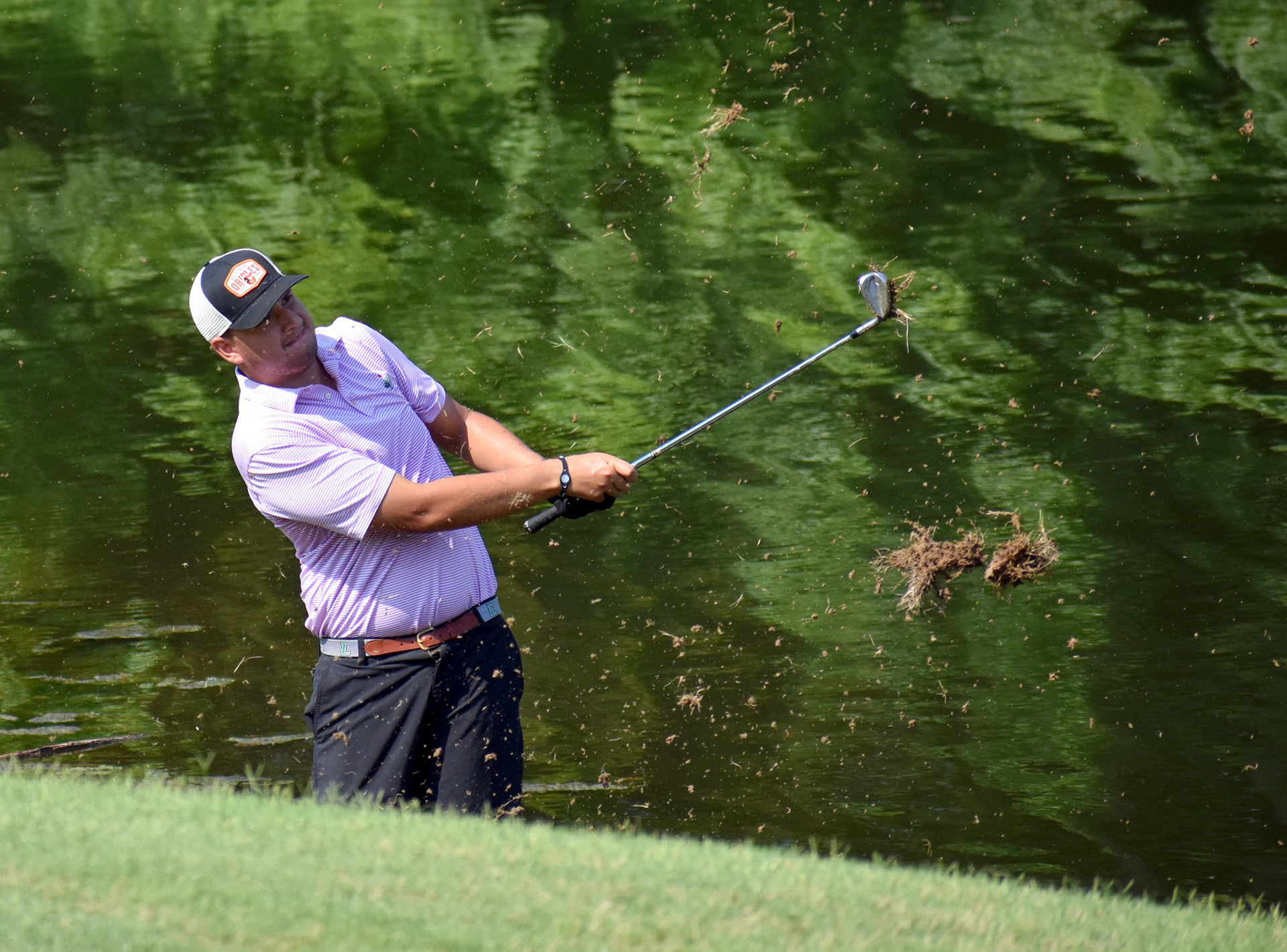 Brandon Berry had to take his shoes and socks off to stand in the pond to hit this one.