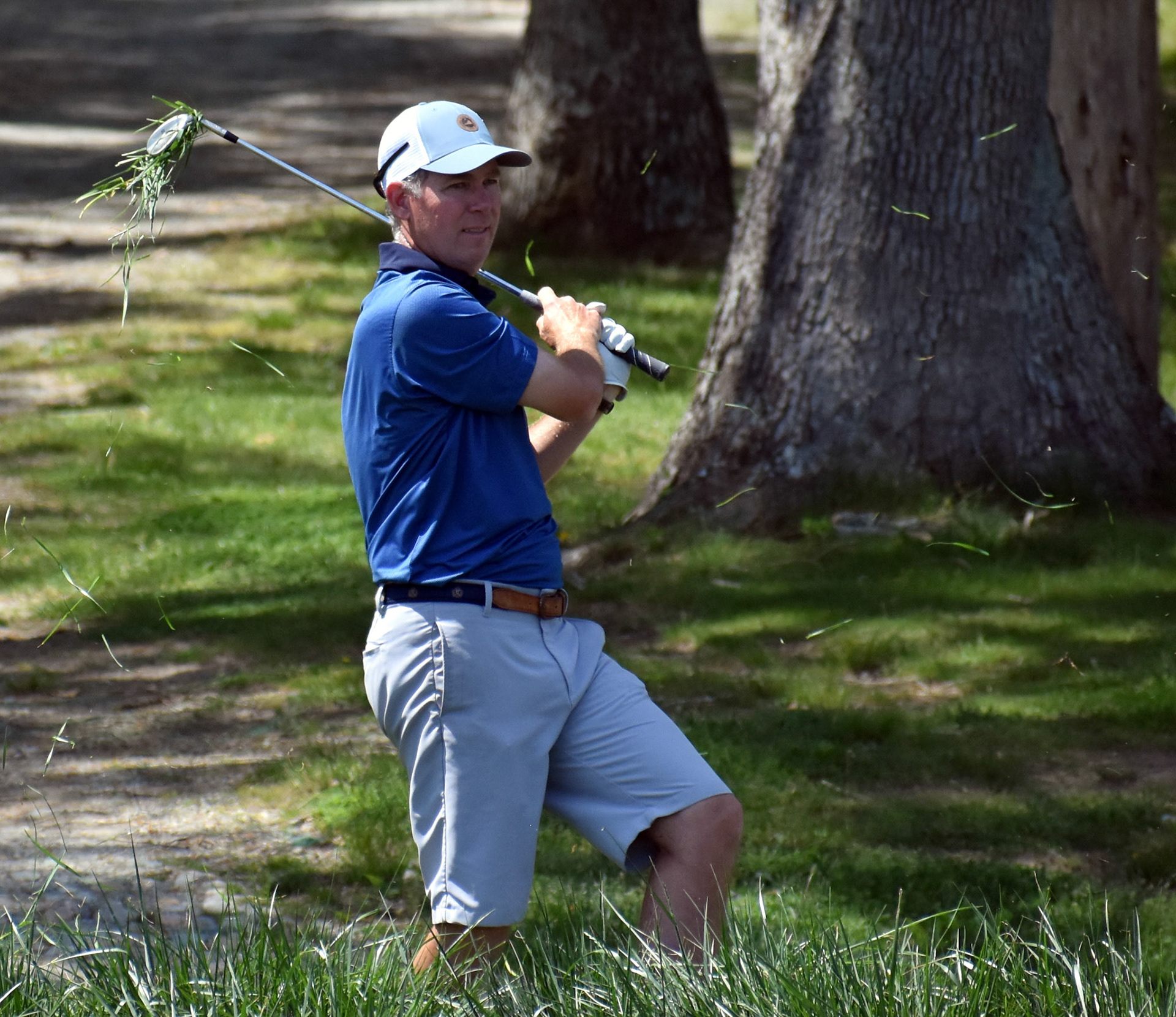 Willow Oaks' Steve Serrao takes a chunk of tall grass with him after hitting out of the muck near 14 green.