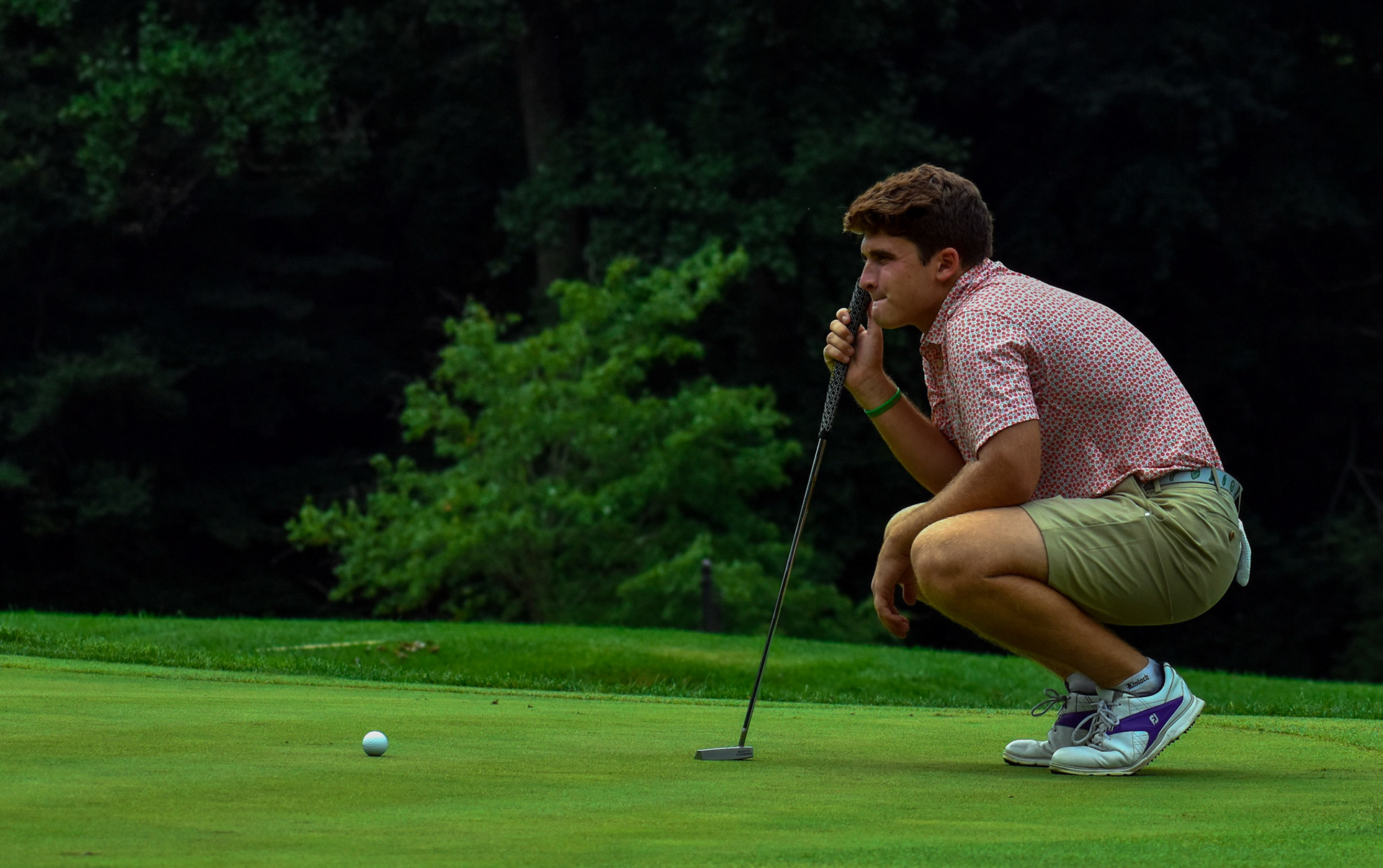 Garrett Kuhla reads his putt on 11 green
