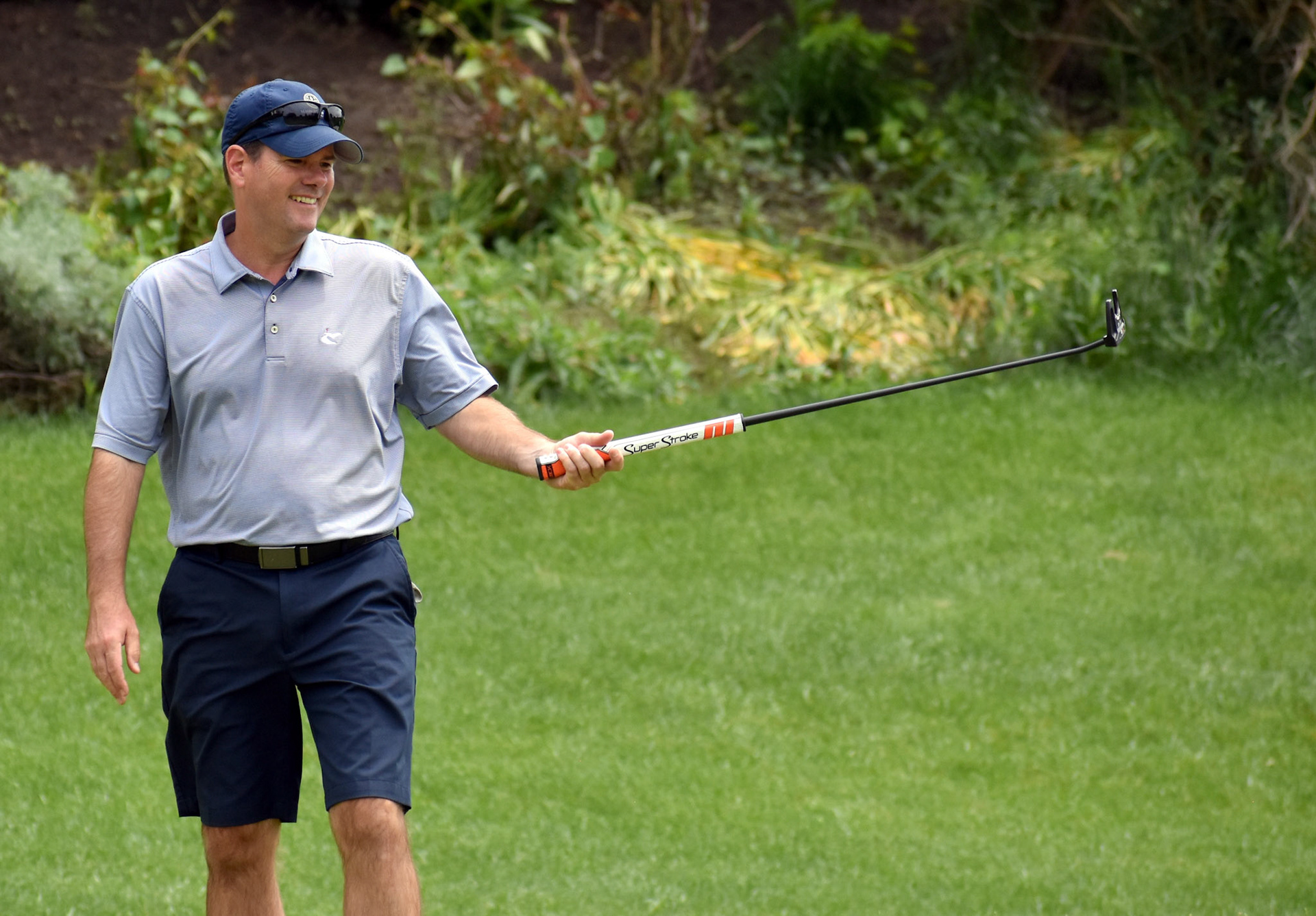 Kevin South laughs as his putt on 14 goes off line.
