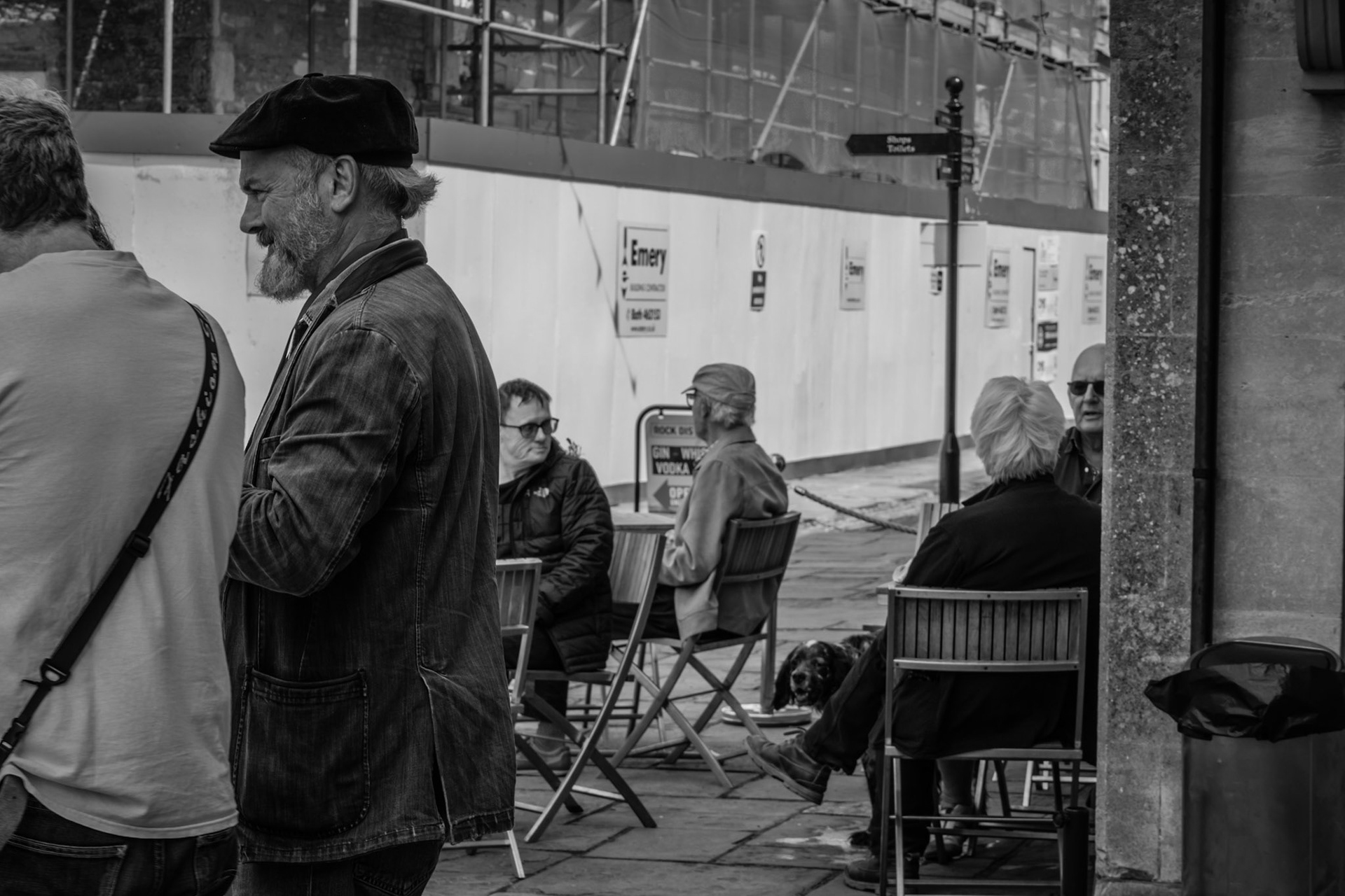 Pavement cafe outside Woodies Deli with the bank conversion in the background.