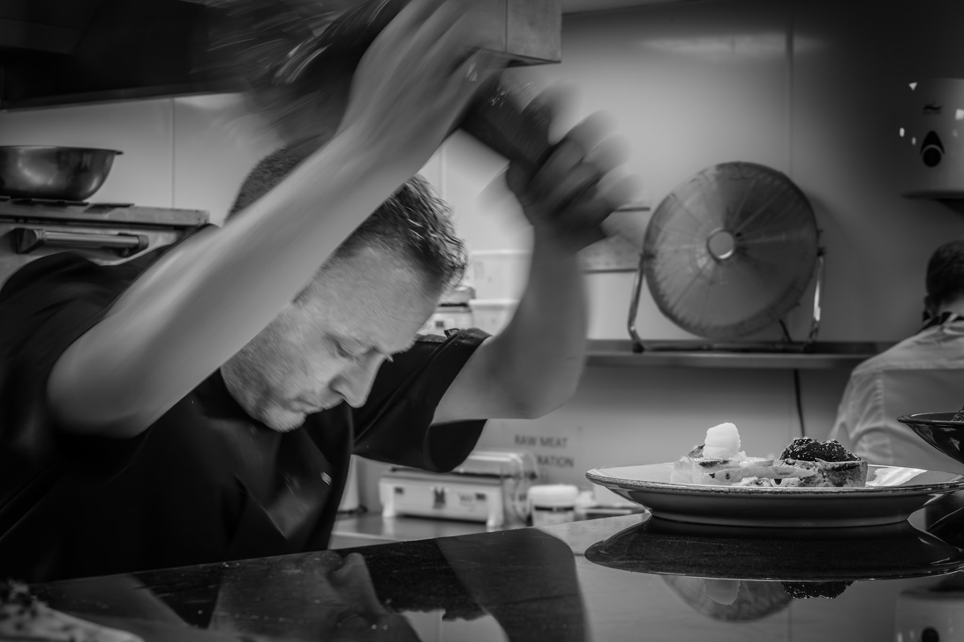 Behind the calm of the dining room lies this — the blur of movement, the sharpness of attention, and the artistry of the plate.