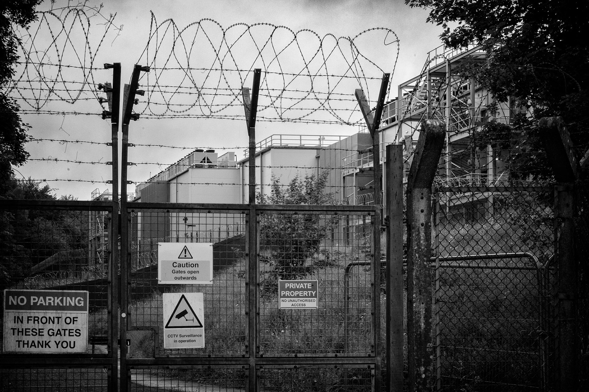 Signs, barbed wire and surveillance cameras guard the entrance to a data centre. A planning application proposes building another on the adjacent Donkey Field — long used by the public for walking and play. If approved, the path will end here.