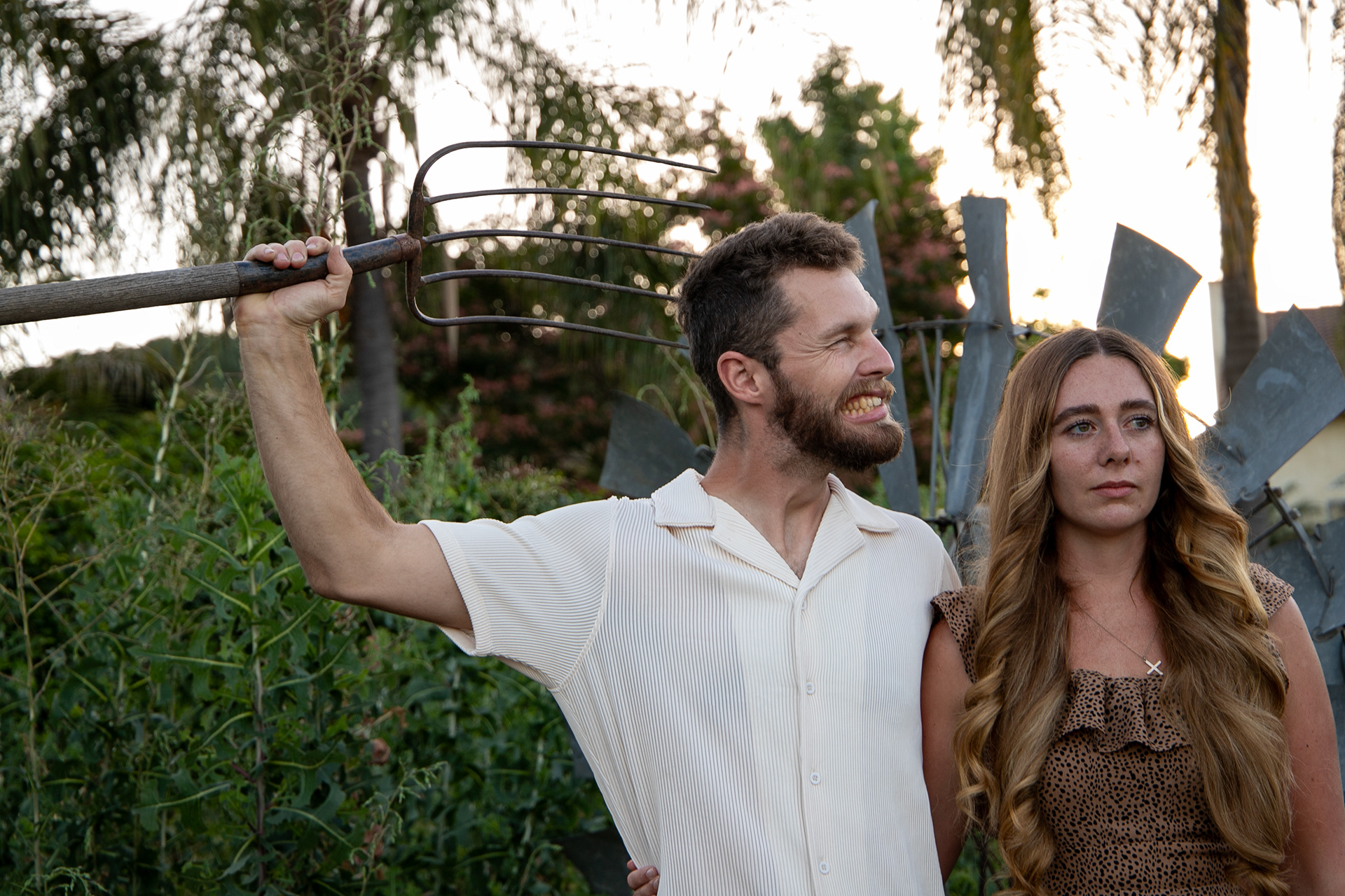 This couple shares a funny moment during their photo session. Adding props can be a fun a hilarious way to make memories.