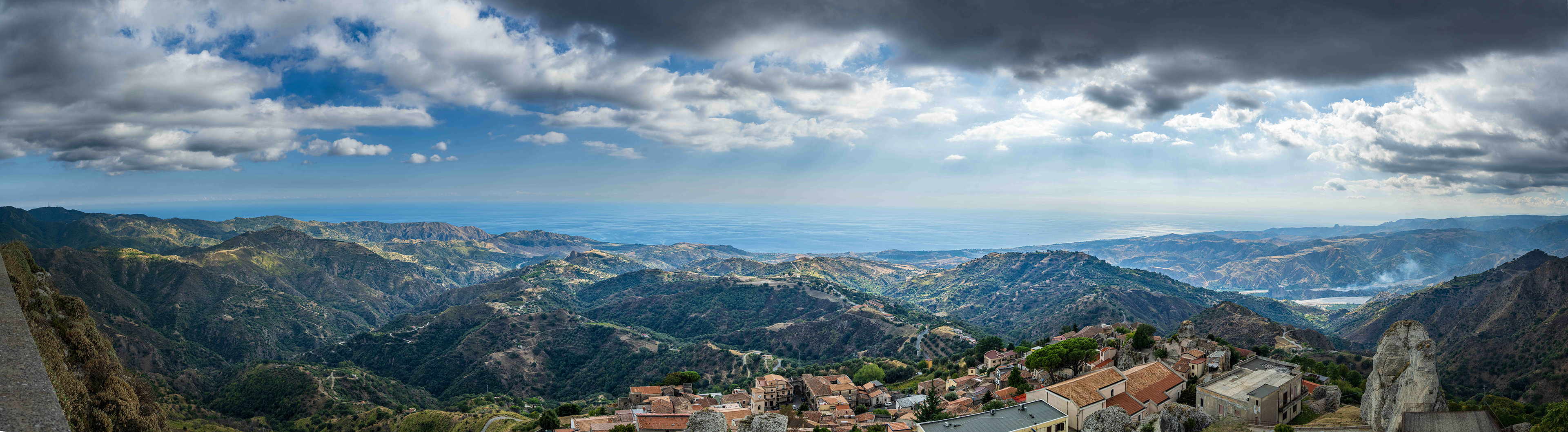 A panoramic view from the top of an Italian hill town looking out towards the ocean.