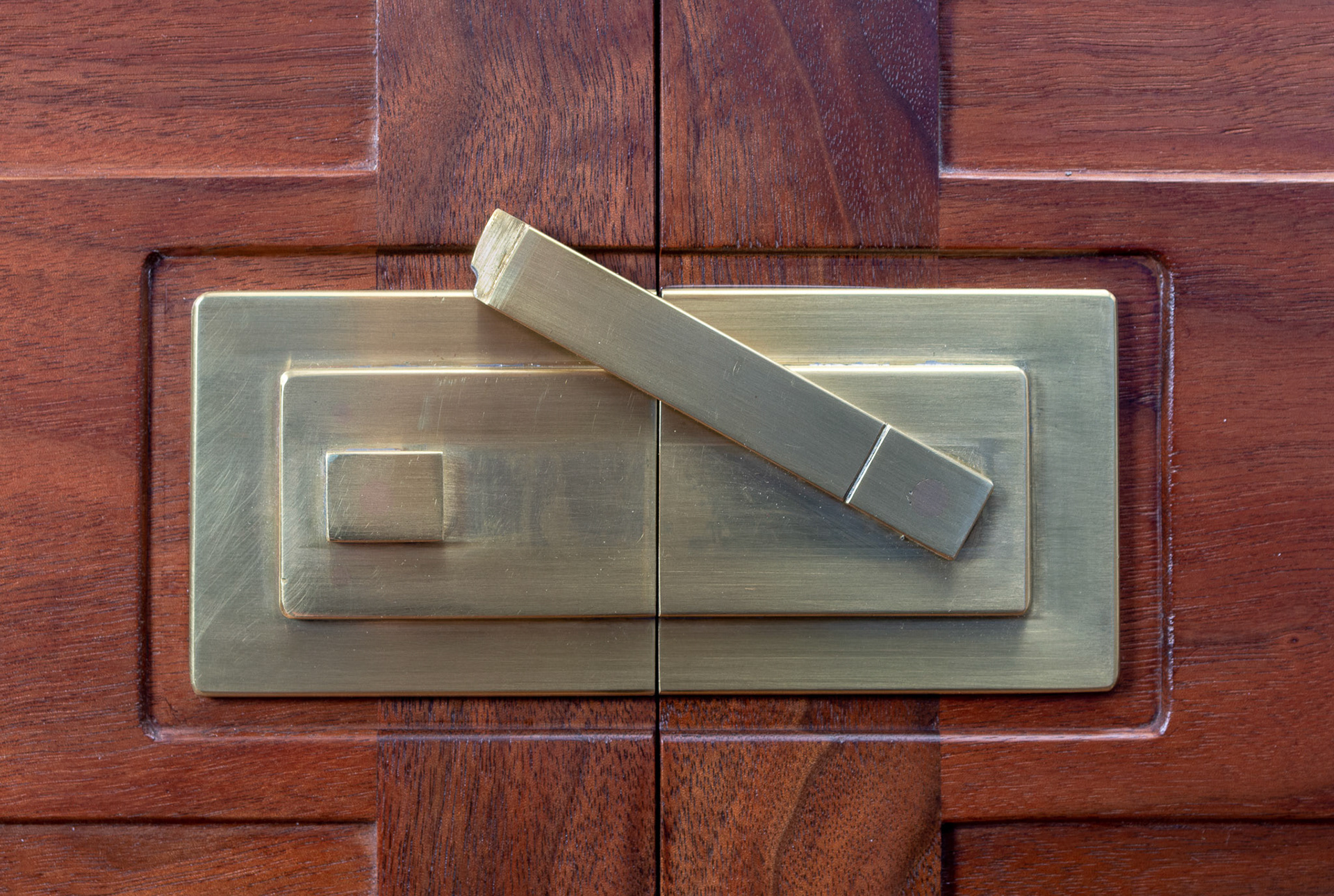 There is a pin in a slot on the back side of the hasp that limits it's swing.