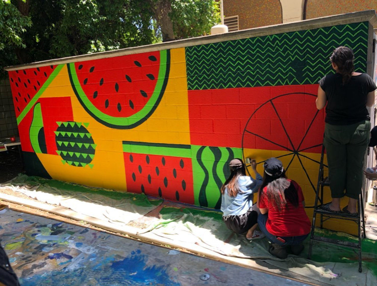 Putting final touches on the UC Davis Pixel Design Club mural.