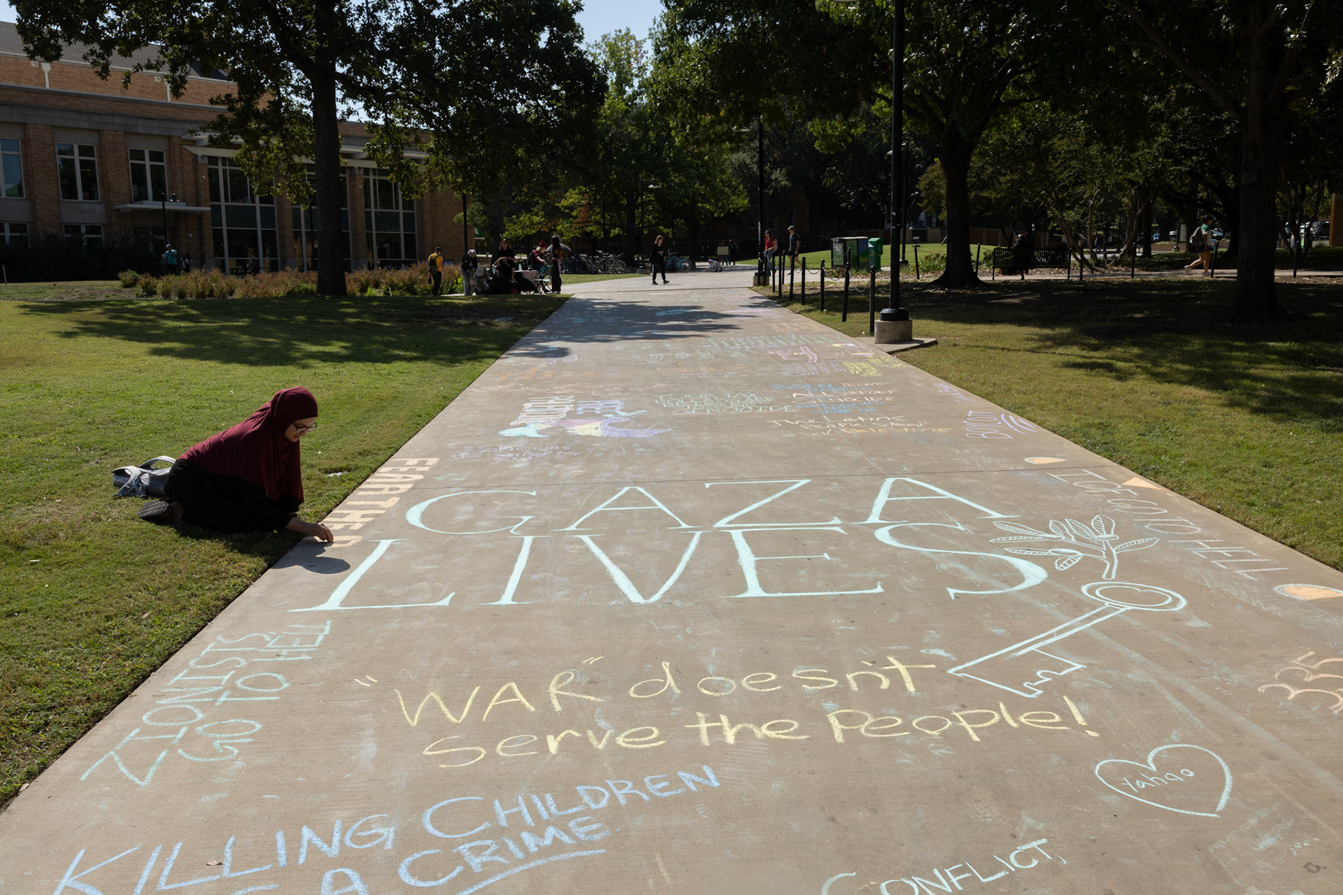 FEAR THE PRAYERS OF THE OPPRESSED- Senior Tanya writes "Fear the prayers of the oppressed" during the 'Week of Rage' Chalk the block on Oct. 8.  By Alaina Jones