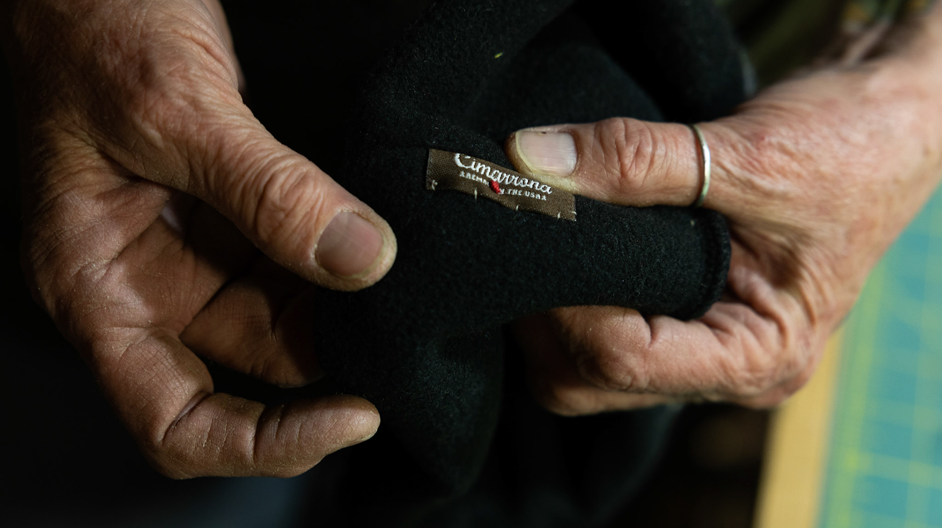 A HEART IN HAND- Leslie Kregel tilts her hands to the camera on April 29, 2024, revealing a small red heart sewn on the tag. She explained, she recycles thrifted materials by creating new hats, giving them a second life. Each hat is distinguished by a small heart sewn into the seam, a signature of her work, and she sells them online while also gifting them to those in need. By Alaina Jones