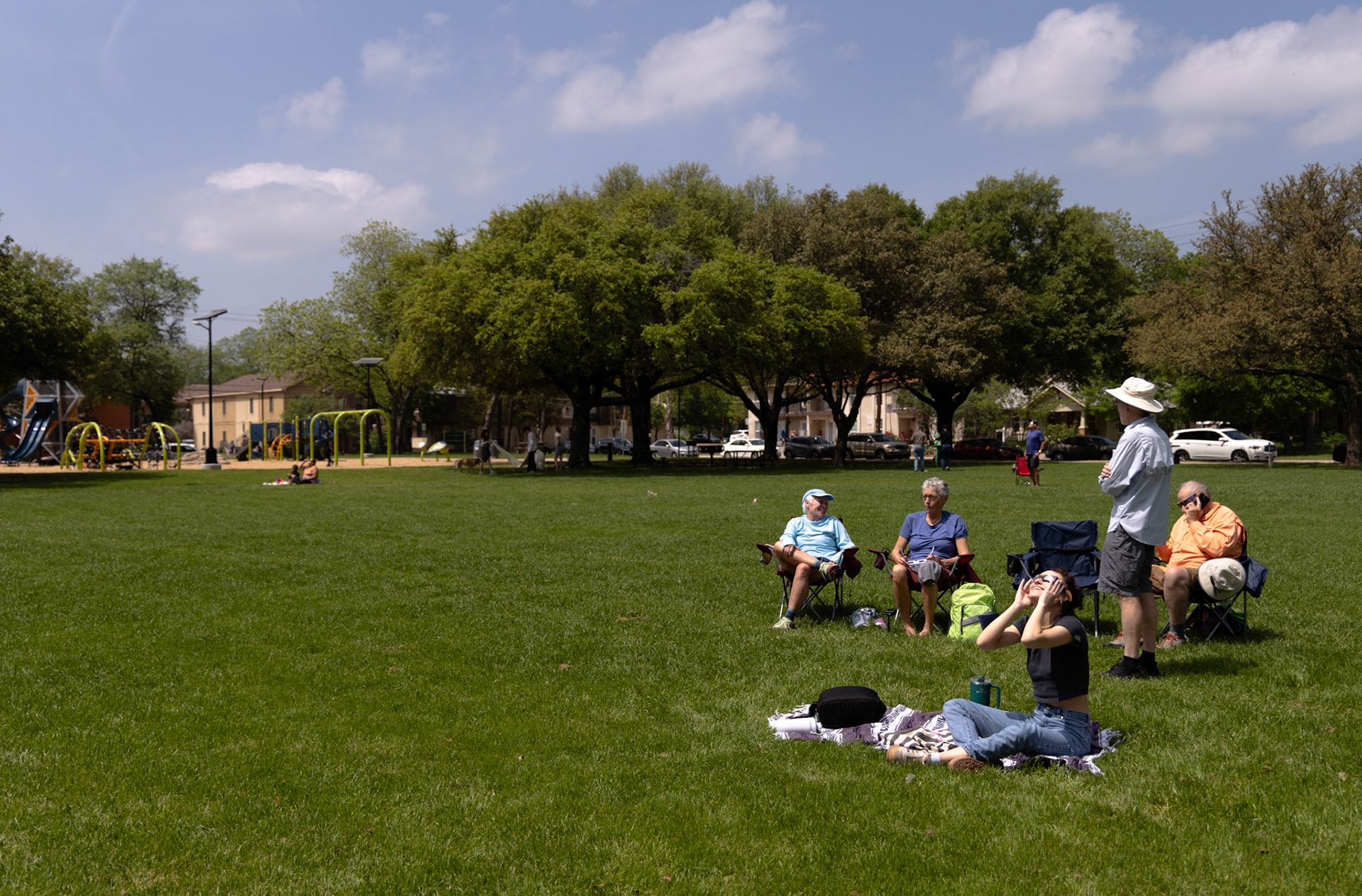 ECLISPE- Five friends, Lisa Larsen, Billie Miller, Bill Long, Ray Flaherty and Kalie Reed excitedly examine the sky on April 8, 2024 before totality is reached. Larsen, Miller, Long and Flaherty planned traveling to Quakertown park from Montana in 2017 to examine the eclipse for celebrating Miller and Flaherty’s birthday’s and made friends with Reed after gifting her with a pair of eclipse glasses. “We have had a 50 year long friendship and we still feel young. Celebrating with my friends while watching my first eclipse has been my best birthday yet,” Miller said. “ You know aging is like the eclipse it goes by and then suddenly it is totality.”   By Alaina Jones