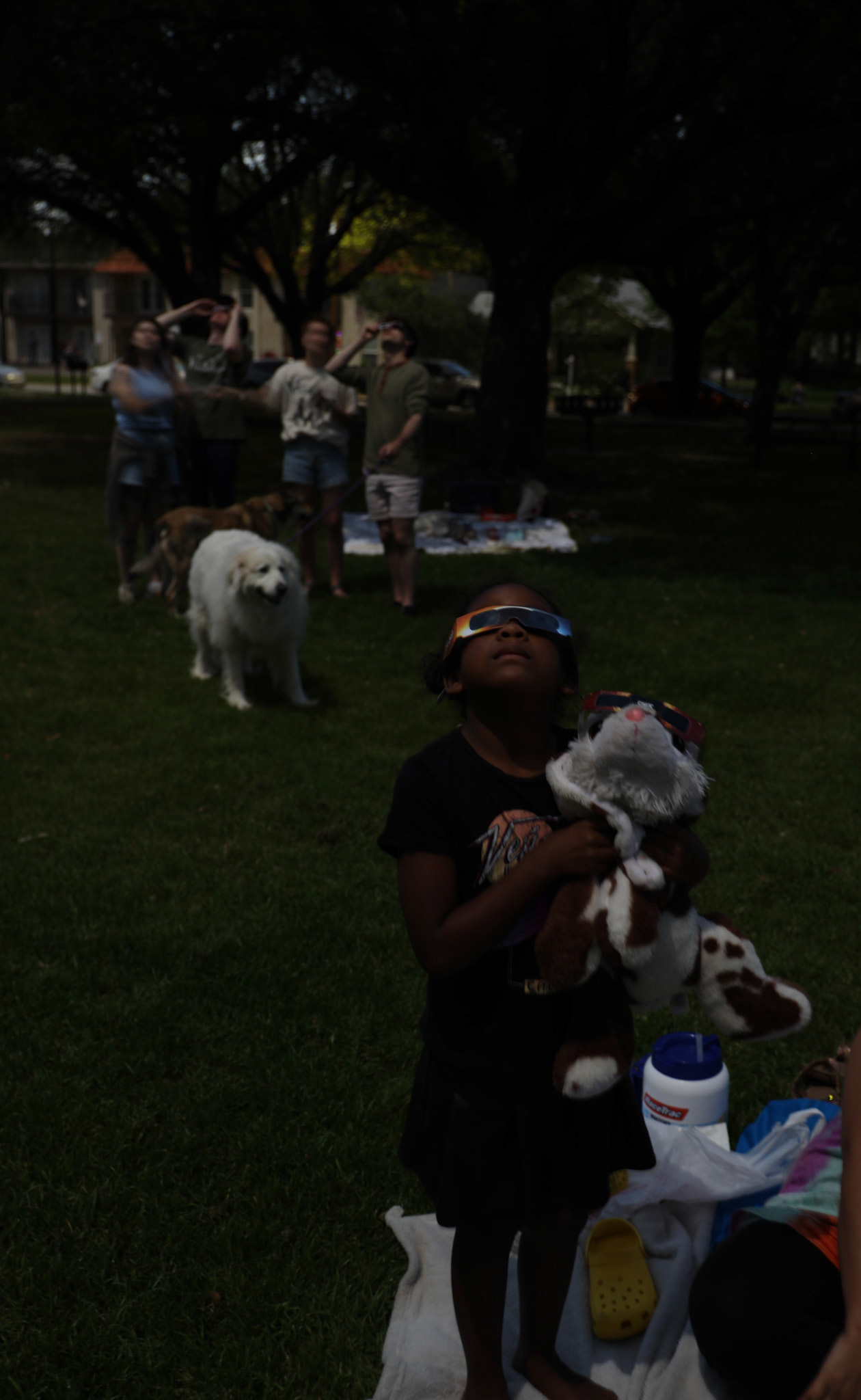 STOLEN SUNLIGHT- Griselda Zuniga and her daughter Marla Zuniga observe the April 8, 2024 eclipse during full totality at Quakertown Park. “I don’t see anything mom,” Marla said.   By Alaina Jones 