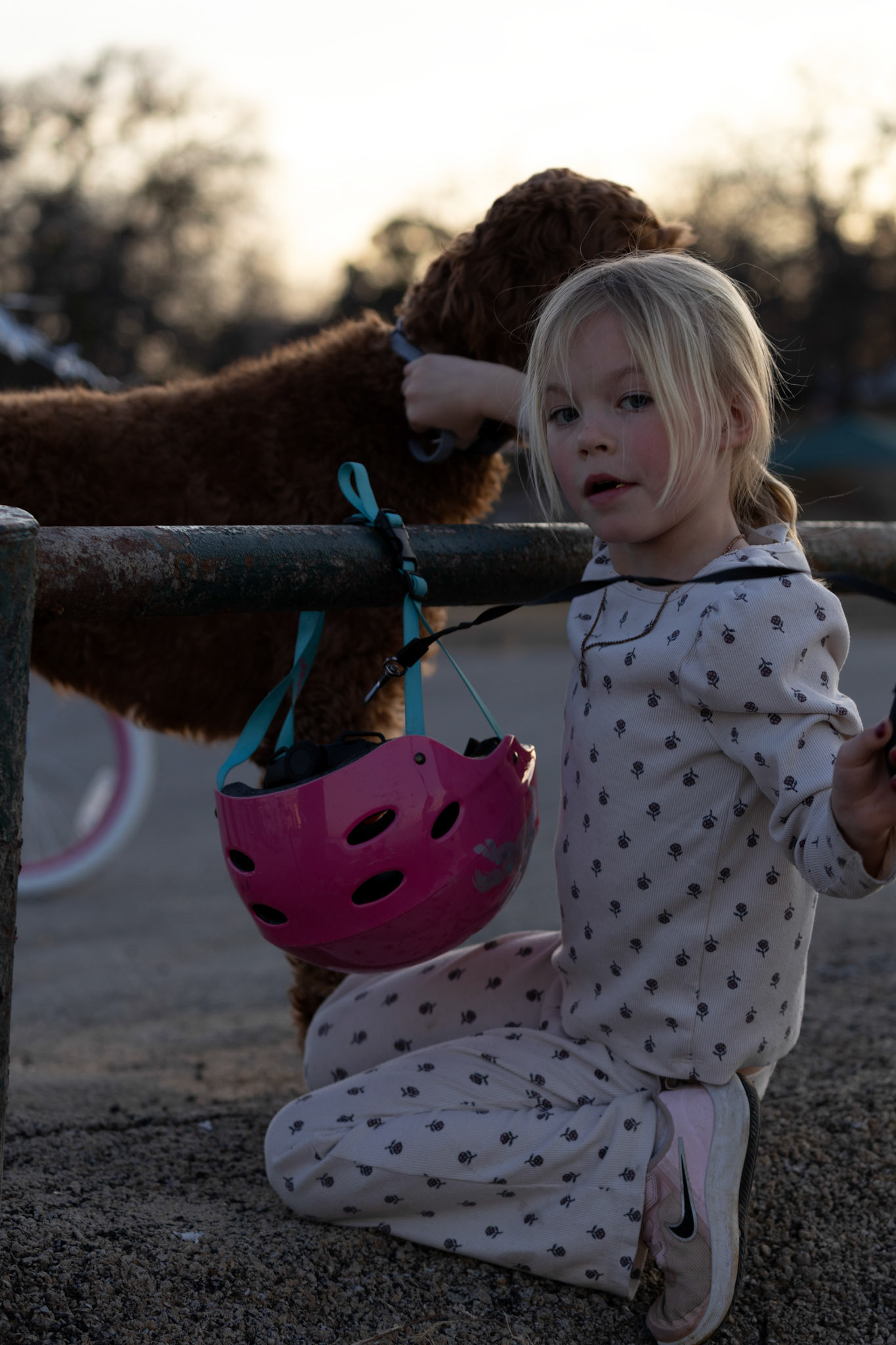 PEDALS AND PAWS- Trevor Ashlock’s daughter unties the family dog’s leash on February 2, 2025 from a pole in hopes of heading home sooner. She loves riding her pink and purple bike while wearing her favorite blue spiky mohawk helmet. Photo by Alaina Jones 