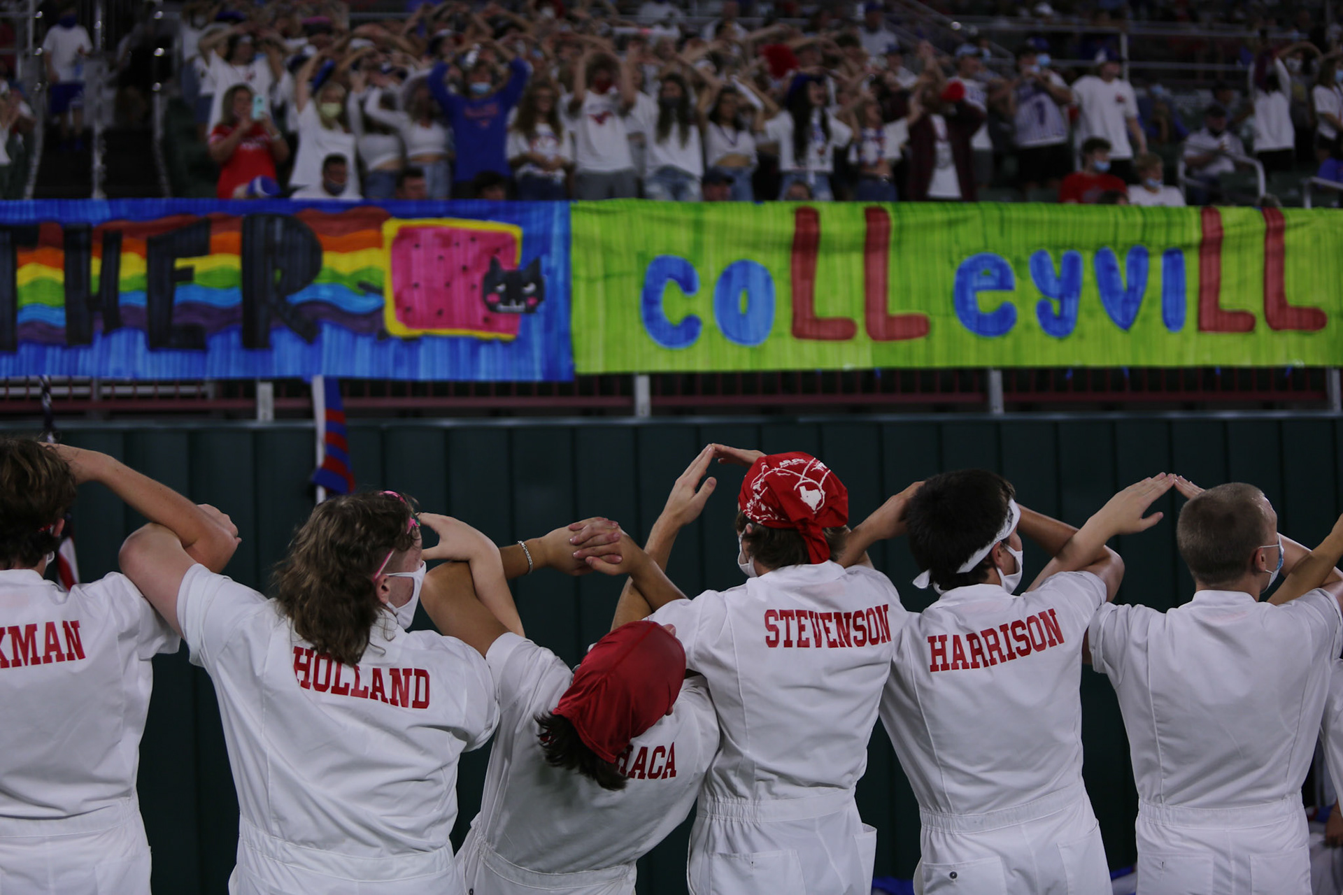 DOWN TO THE WIRE- Grapevine High School Spirit Rustlers lead a chant during the Colleyville Heritage Rivalry game held at the Mustang Panther Stadium on Aug. 27, 2021. The rivalry game is known as The Battle of the  Red Rail. By Alaina Jones
