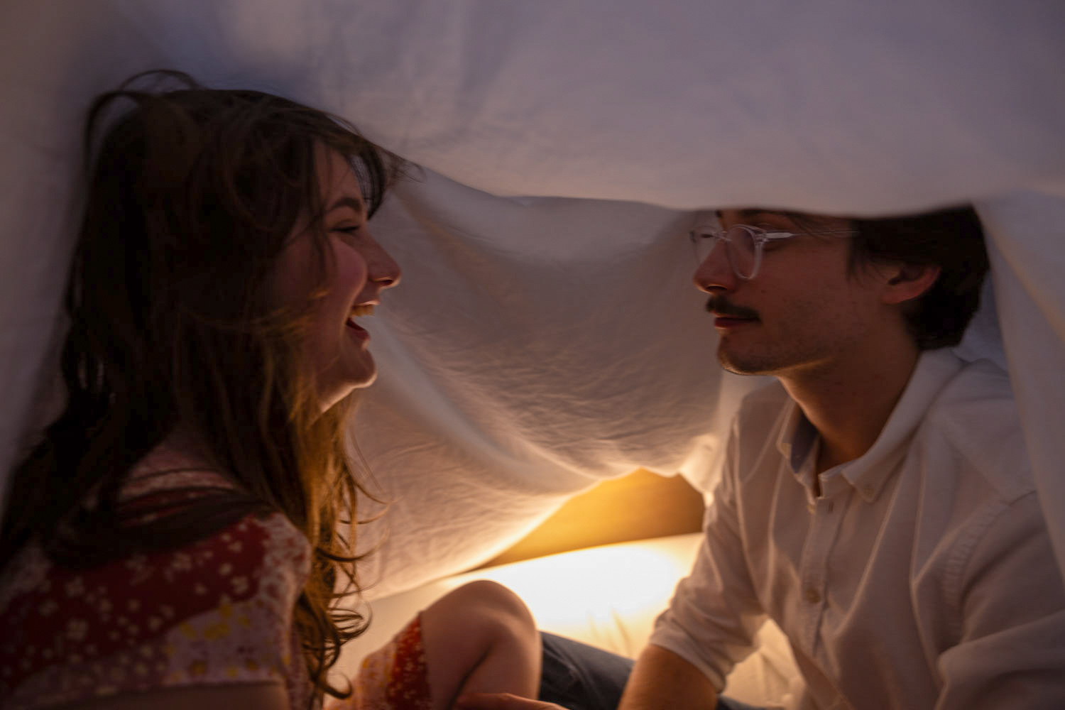 PLAYFUL- White and Workings play under a tent on April 28, 2025 in their Denton downtown apartment. “Sometimes with work, school, the award ceremony, finals and moving, I forget how important it is to live in the moment, but Bryce constantly reasures me and helps bring me back,” White said. Photo by Alaina Jones