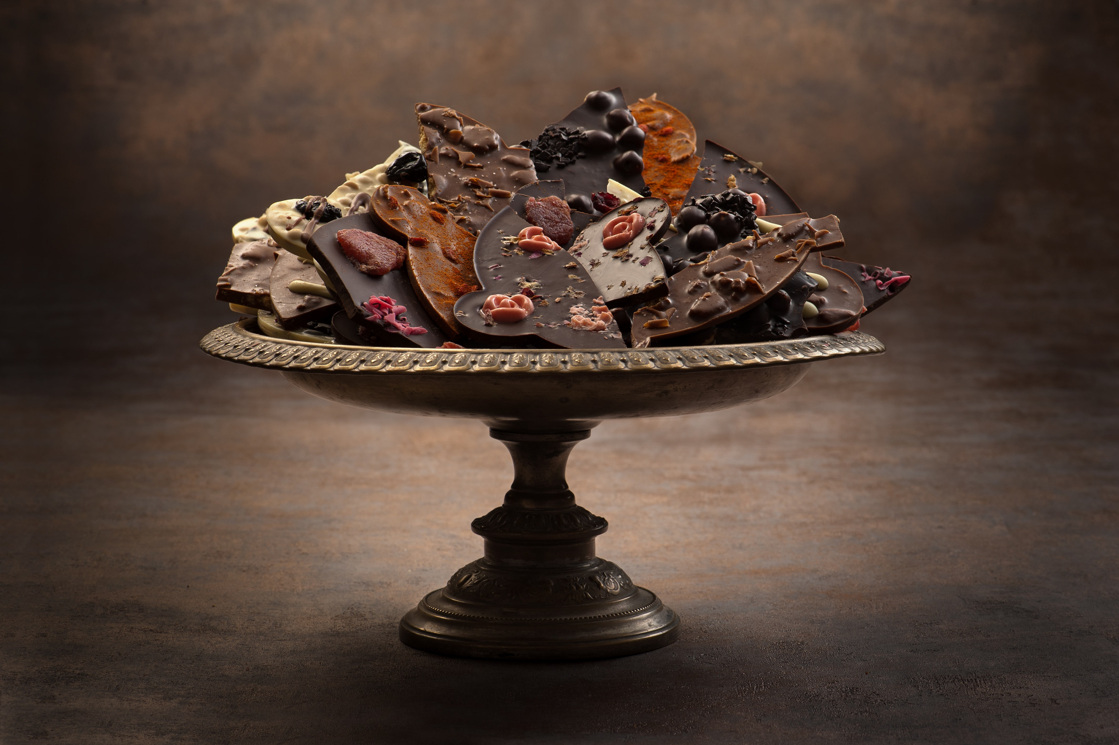 voula gkoti photography various hand made chocolates on a metal disk for laurence-galerie de chocolat
