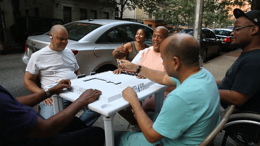 Friends play poker at the Hudson River Greenway on a summer Sunday evening.