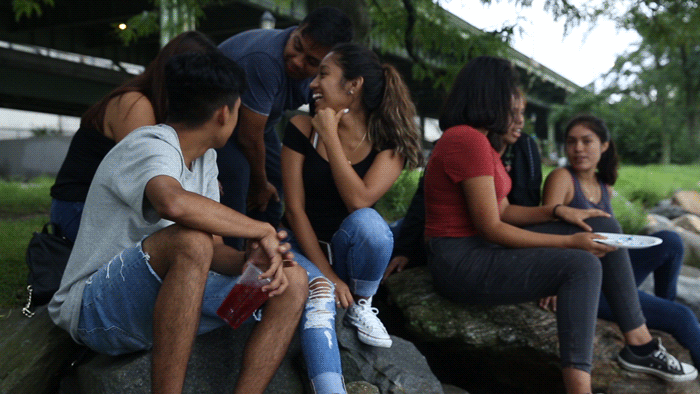 Anthony Martinez (far left) celebrates his eighteenth birthday with close friends at the Hudson River Greenway riverfront.