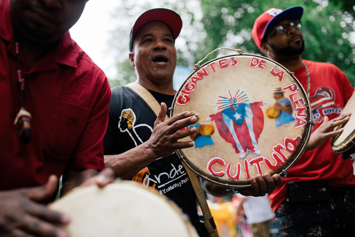 The music group Los Gigantes de la Plena play bomba, a traditional style of music that revolves around percussion, at Fifth Avenue and 75th Street.