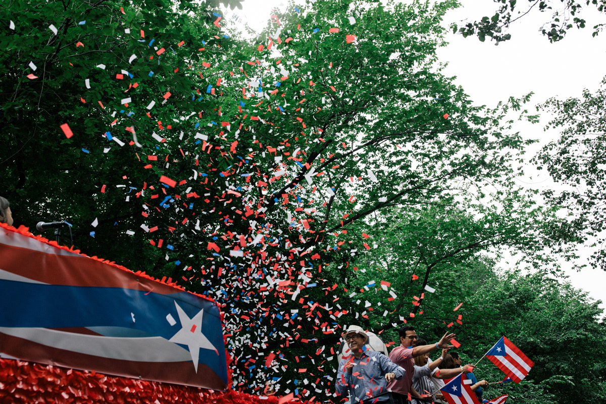 A float operated by the Spanish language channel Telemundo 47 releases confetti and hands out inflatable soccer balls at Fifth Avenue and East 61st Street.