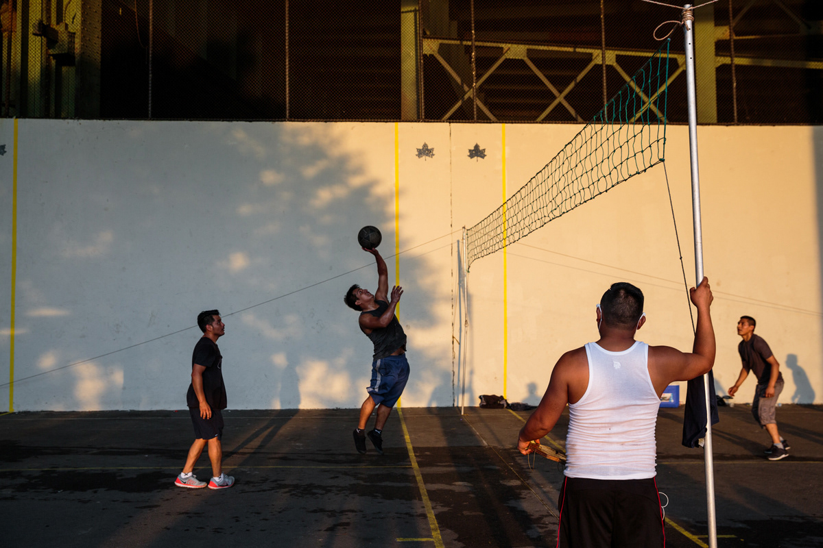 Friends play a game of Ecuavolley, a variant of volleyball invented and played in Ecuador, in the Hudson River Greenway on a summer Sunday evening.