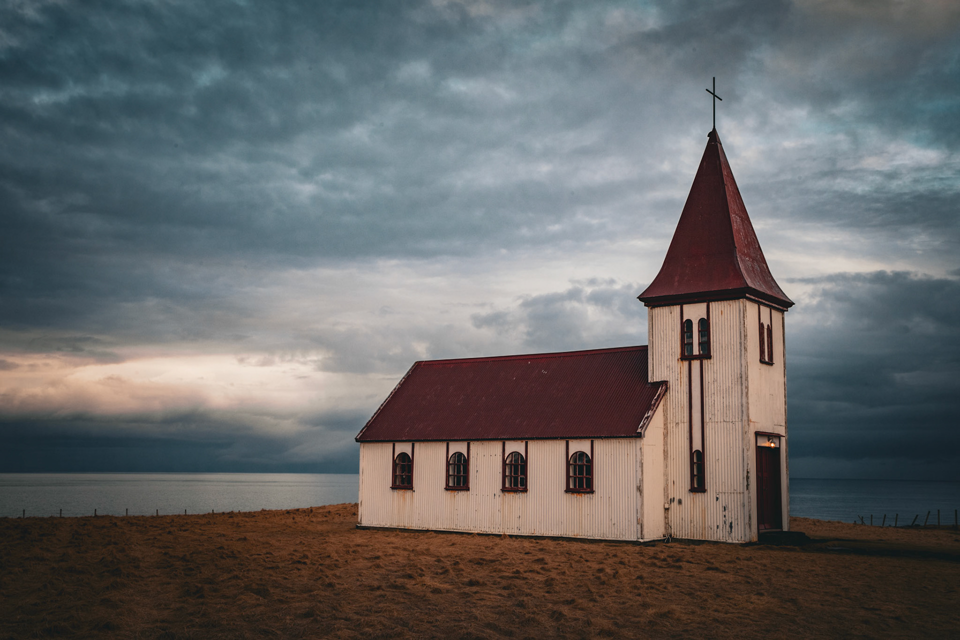 A brooding Atlantic ocean in the background of Hellnar Kirkja on the edge of Snæfellsnes peninsula.