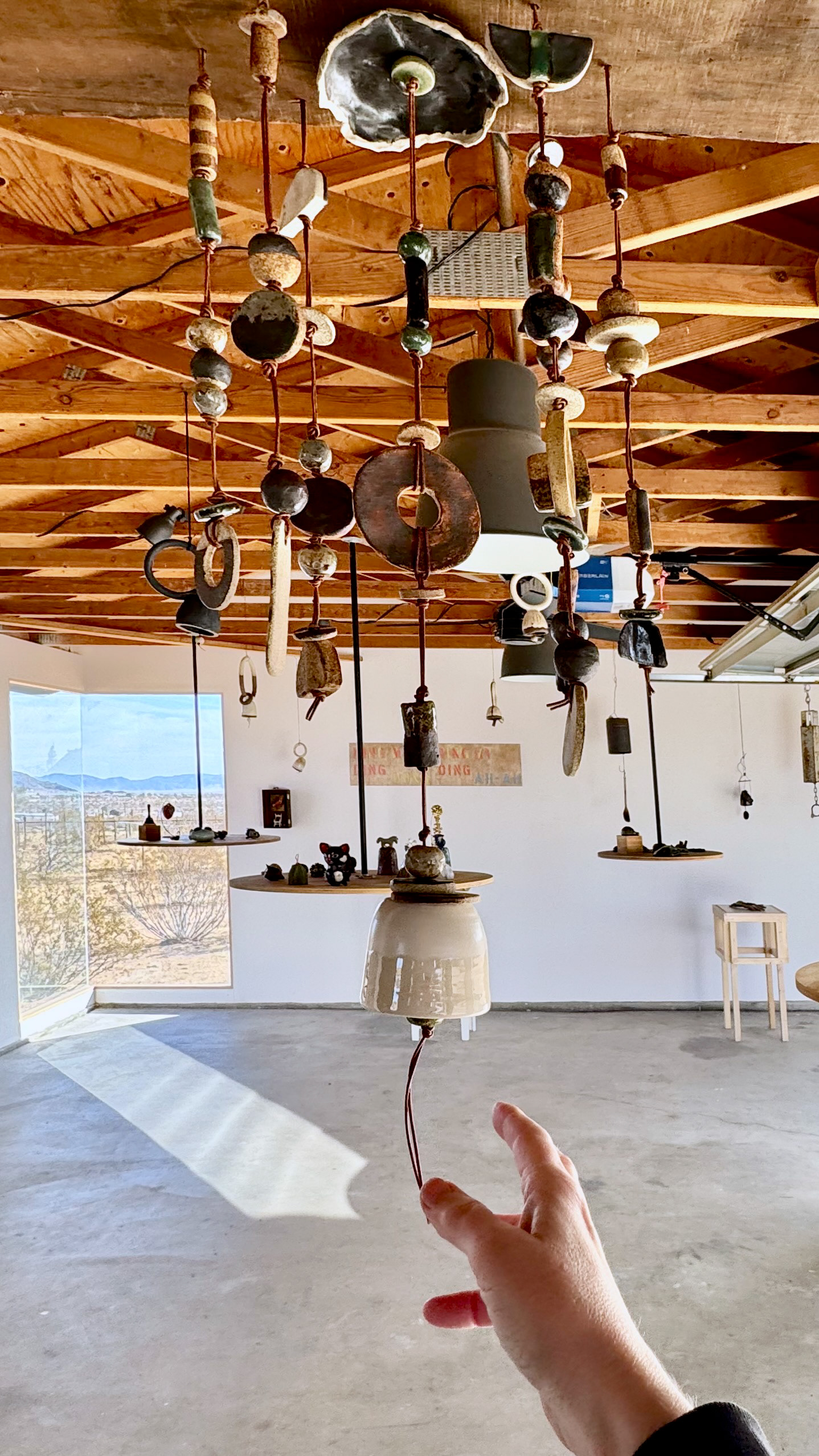 Ring the Bell, 2025, earthenware, glaze, iron oxide, leather, dimensions variable