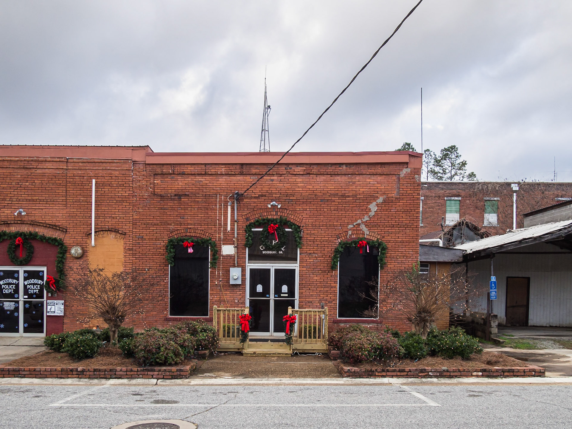 A red brick commercial building decorated with Christmas wreaths in downtown Woodbury, Georgia, in December 2015