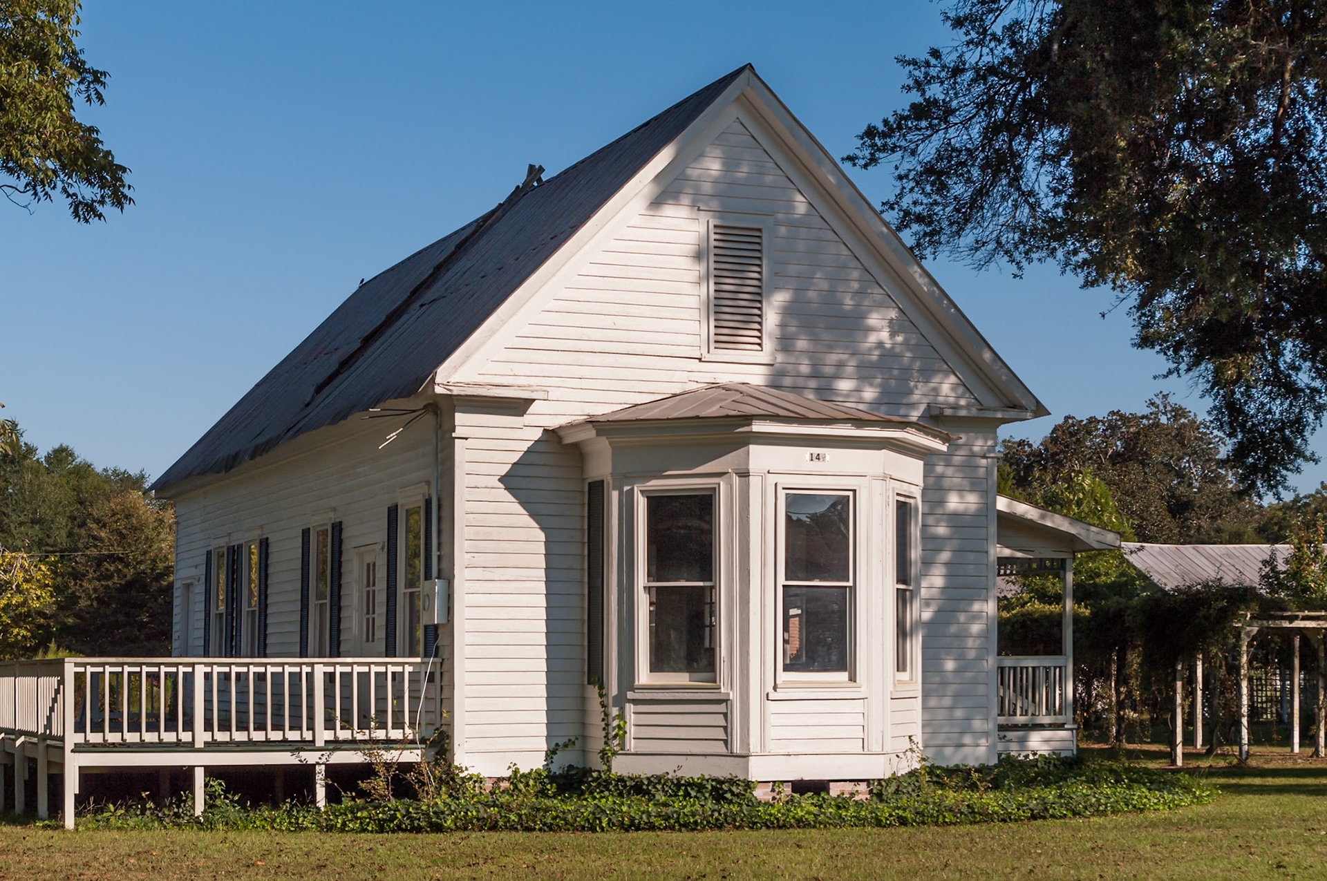 An older residence in Toomsboro, Georgia, with a prominent bay window and traditional Southern architectural details, photographed in September 2013