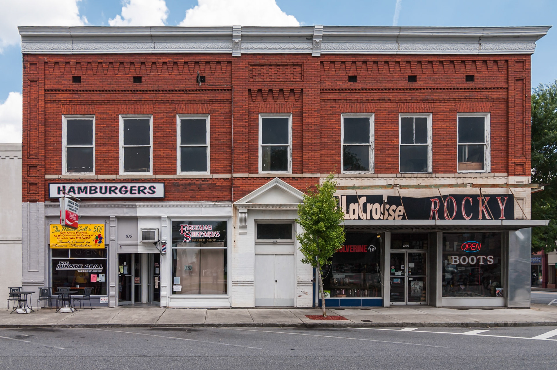 The Minute Grill, Freeman Shepard’s Barber Shop, and LaCrosse Rocky storefronts in downtown Dublin, Georgia, photographed in June 2014