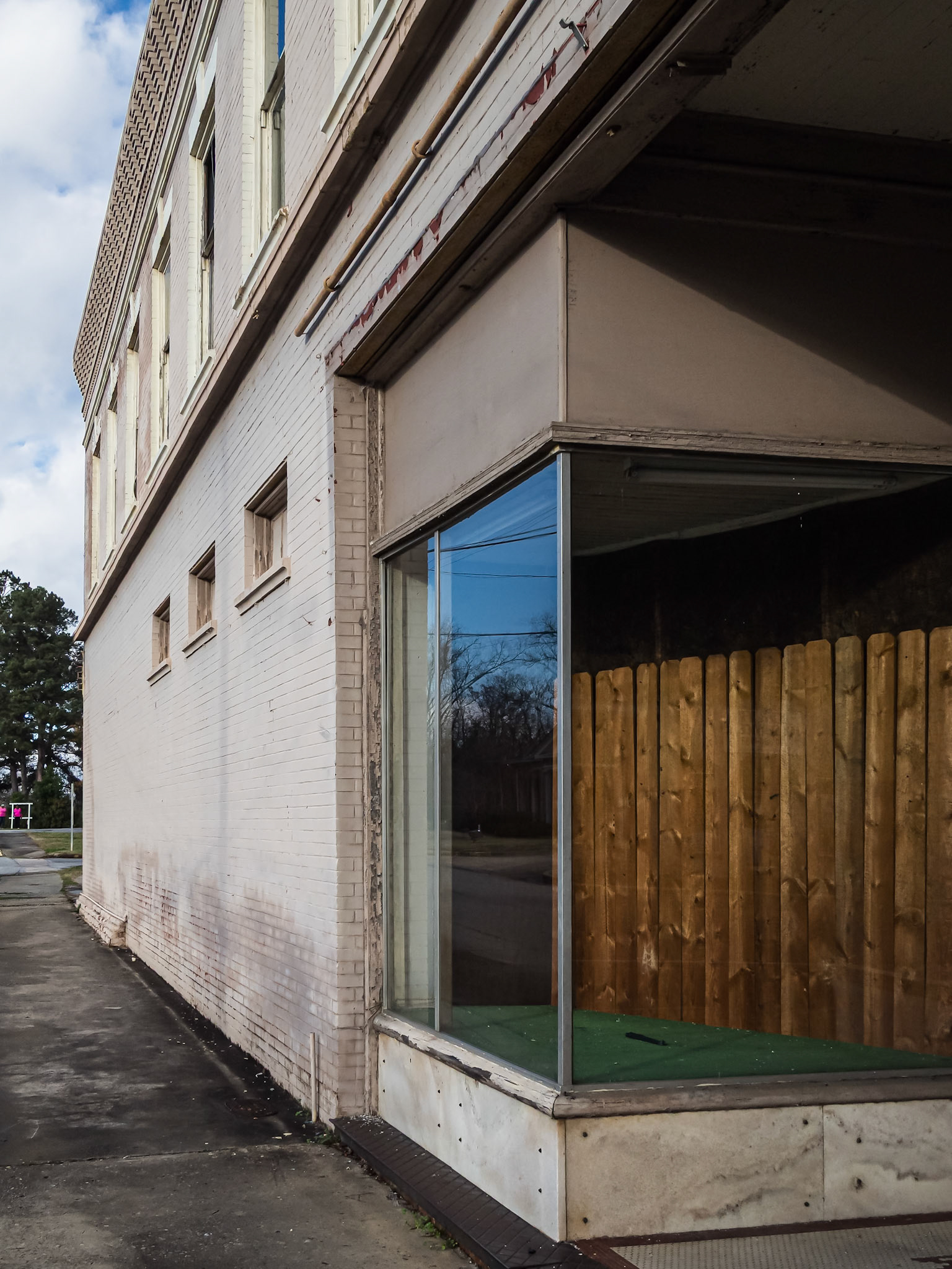 A storefront window and white-painted brick facade in downtown Woodbury, Georgia, in December 2015