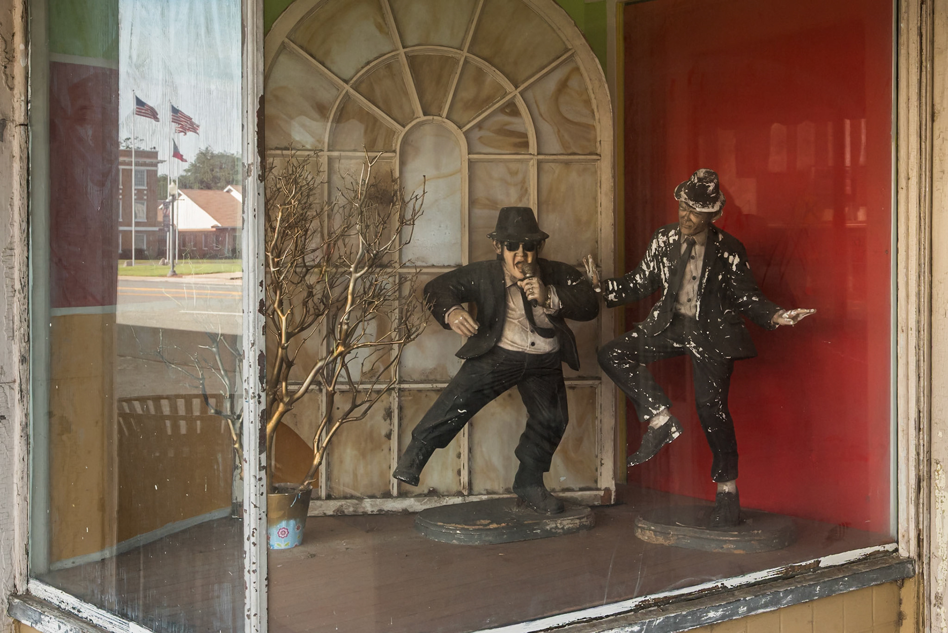 eathered Blues Brothers figures displayed in the window of a downtown Baxley storefront, in June 2024