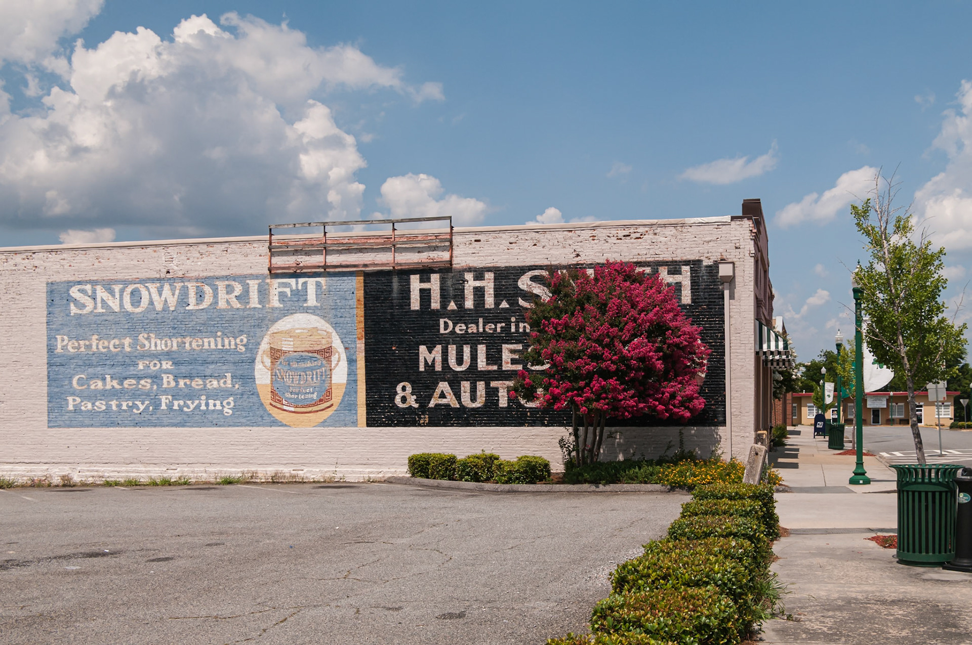Historic painted advertisements for Snowdrift shortening and a mule and automobile dealer in downtown Dublin, Georgia, photographed in June 2014