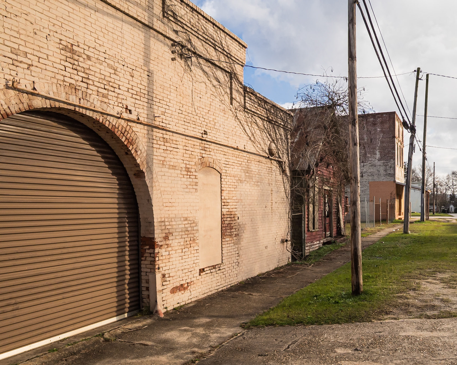 An arched service entrance on an older painted brick building in Woodbury, Georgia, in December 2015