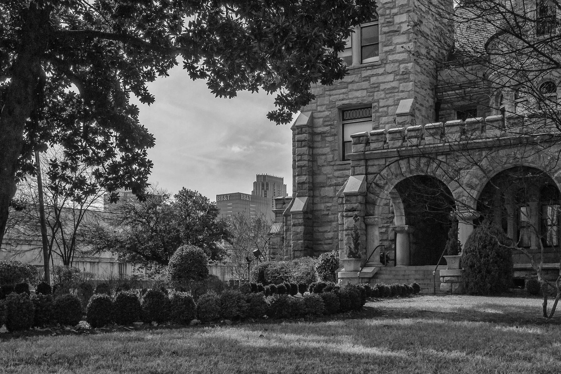 Rhodes Hall on Peachtree Street, with Midtown Atlanta buildings visible beyond the grounds.