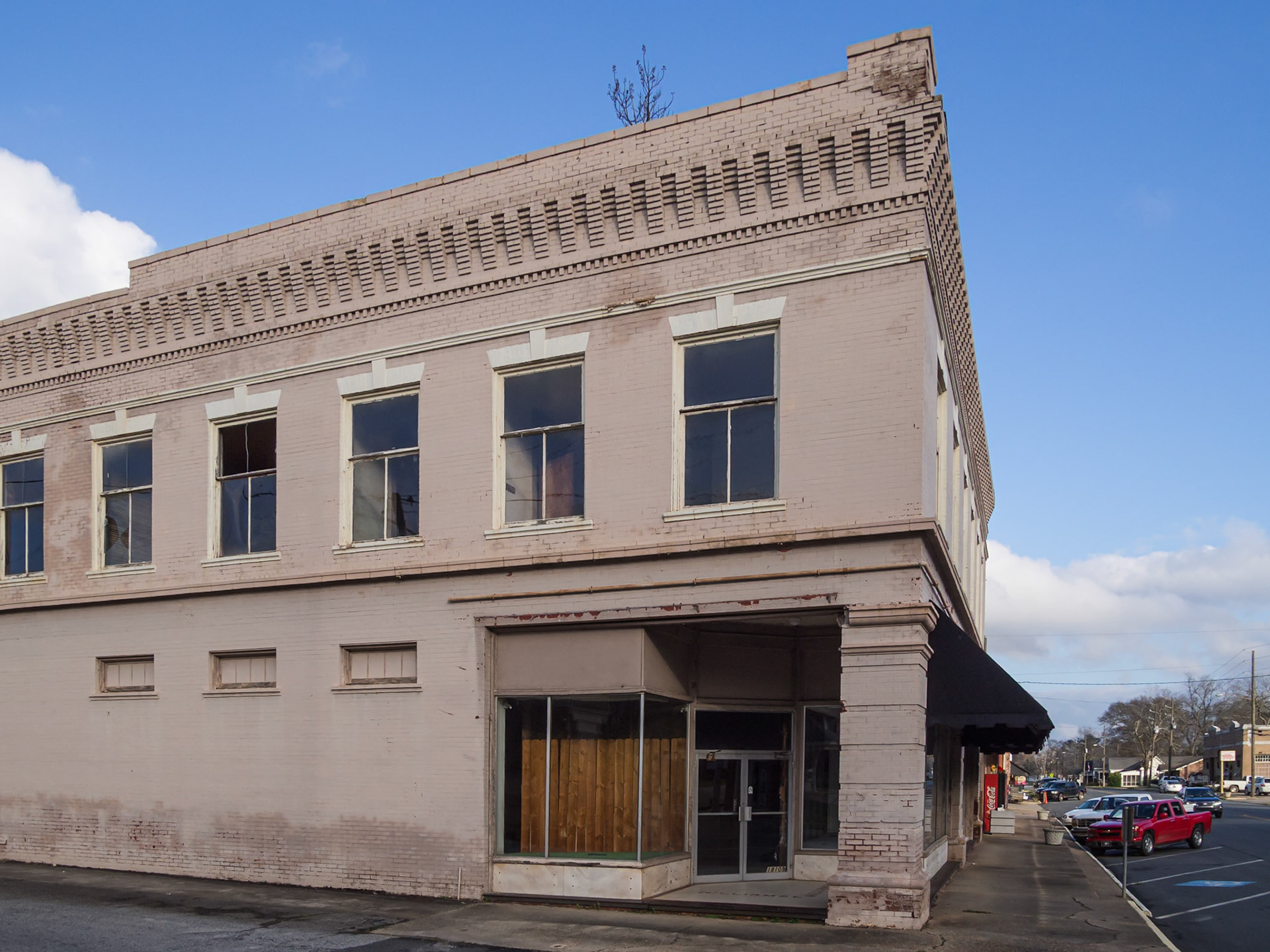 A two-story commercial building with a decorative cornice in downtown Woodbury, Georgia, in December 2015