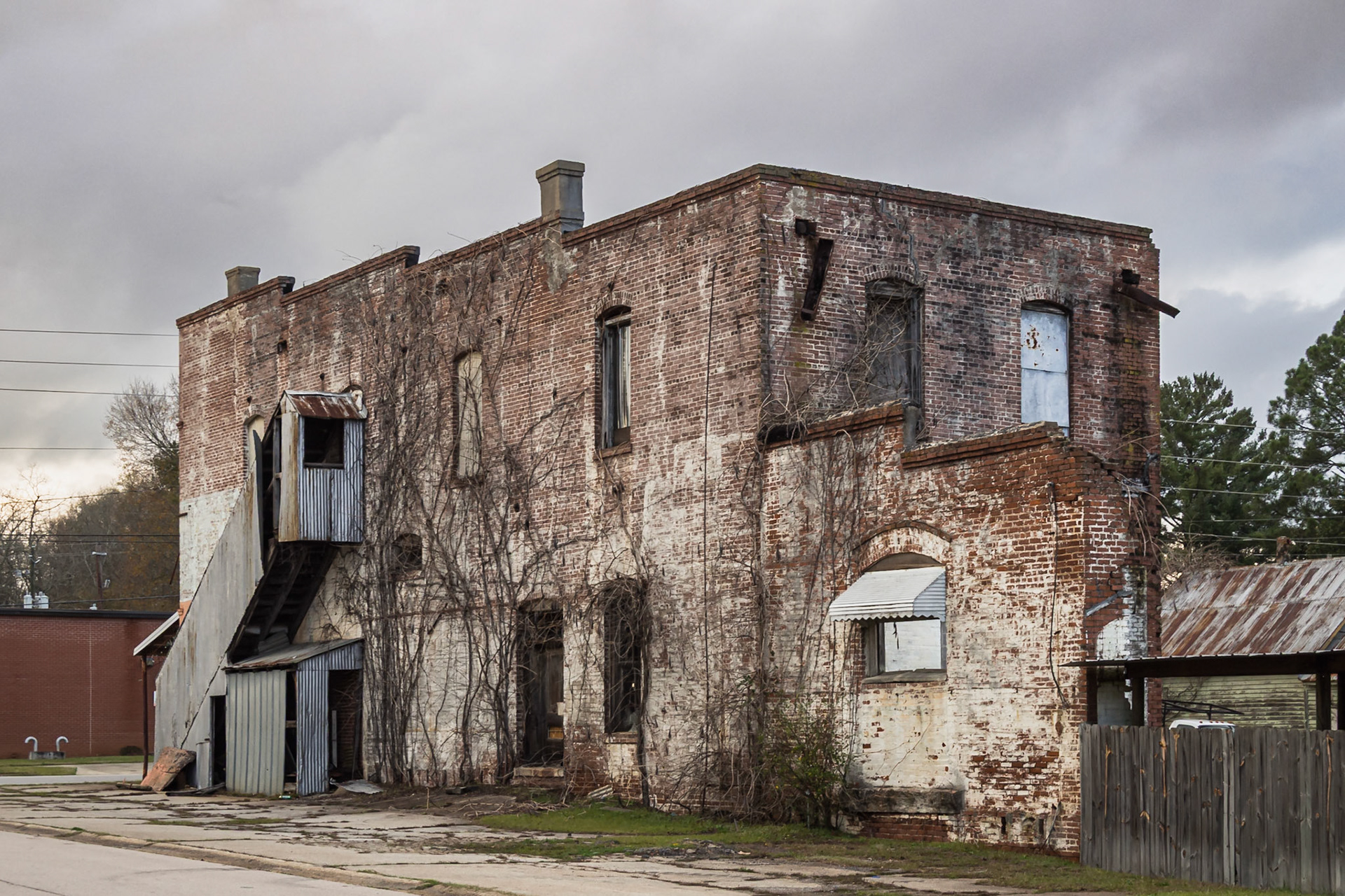 A deteriorating two-story brick commercial building in Woodbury, Georgia, in December 2015