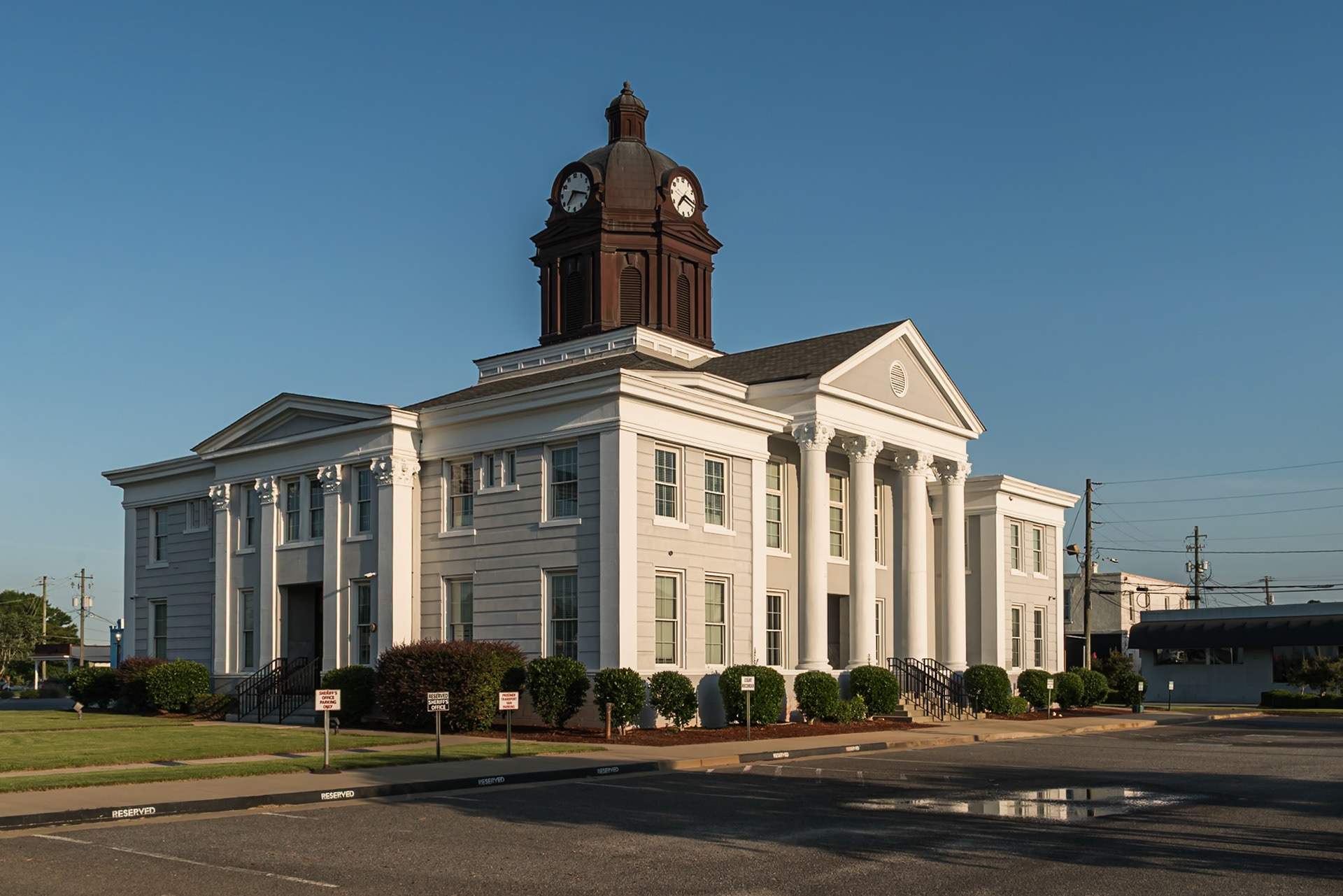 The Appling County Courthouse viewed from an angle in late-afternoon light, in June 2024