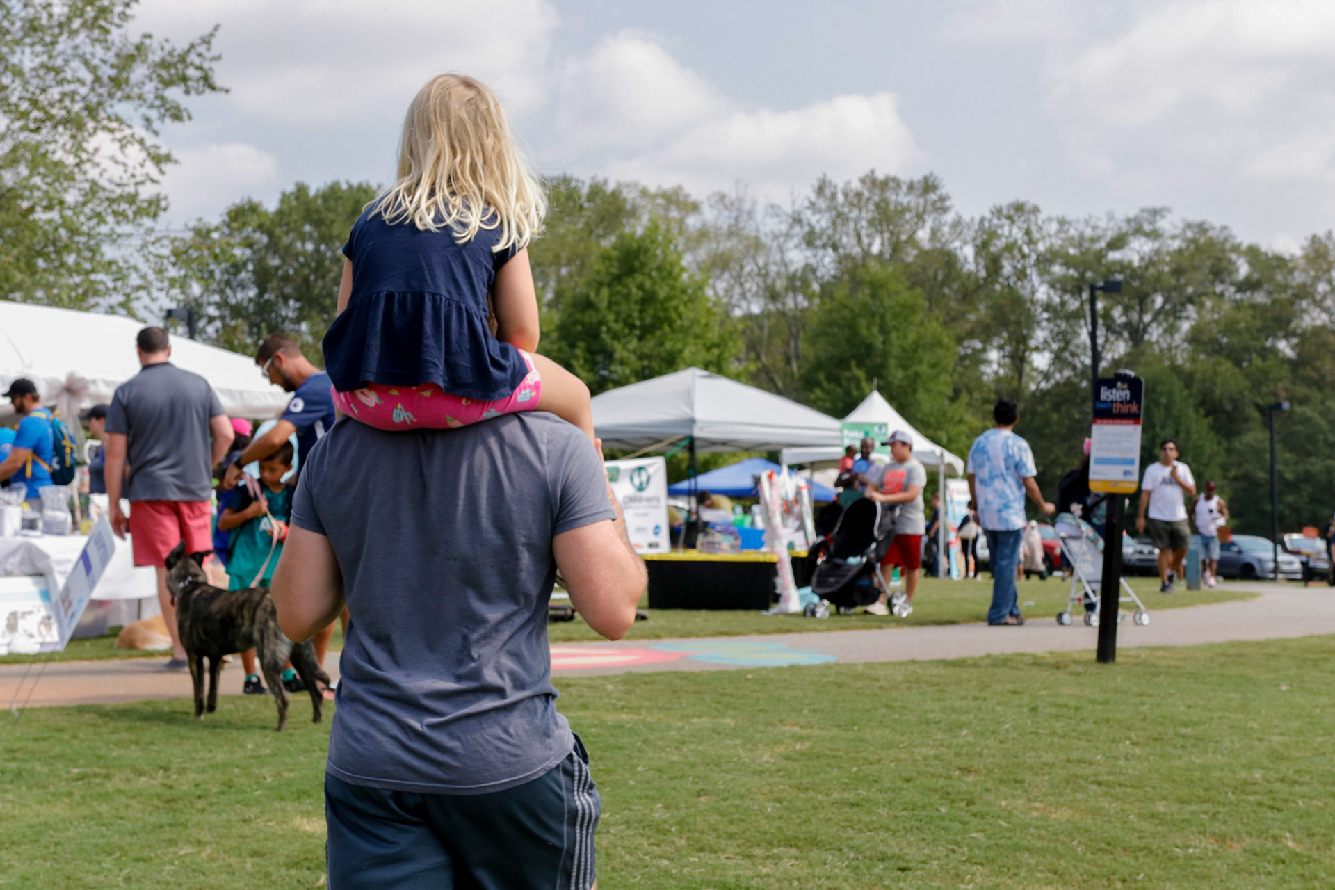 A family walking at the Play at the Park festival