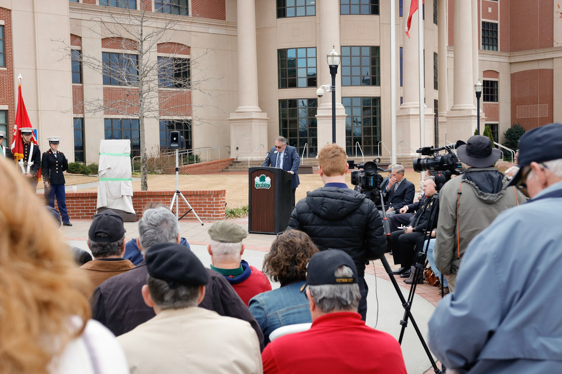Commissioner Dennis Brown speaks at statue unveiling