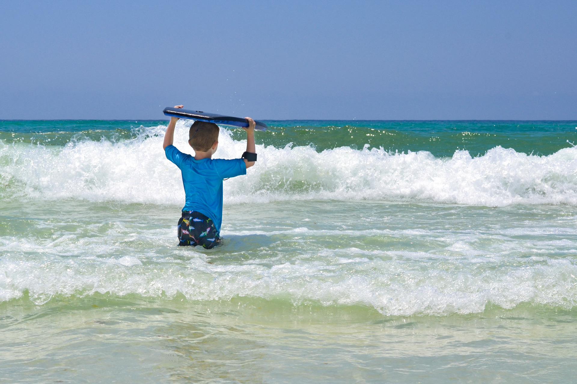 My son getting ready to hit the waves with his boogie board