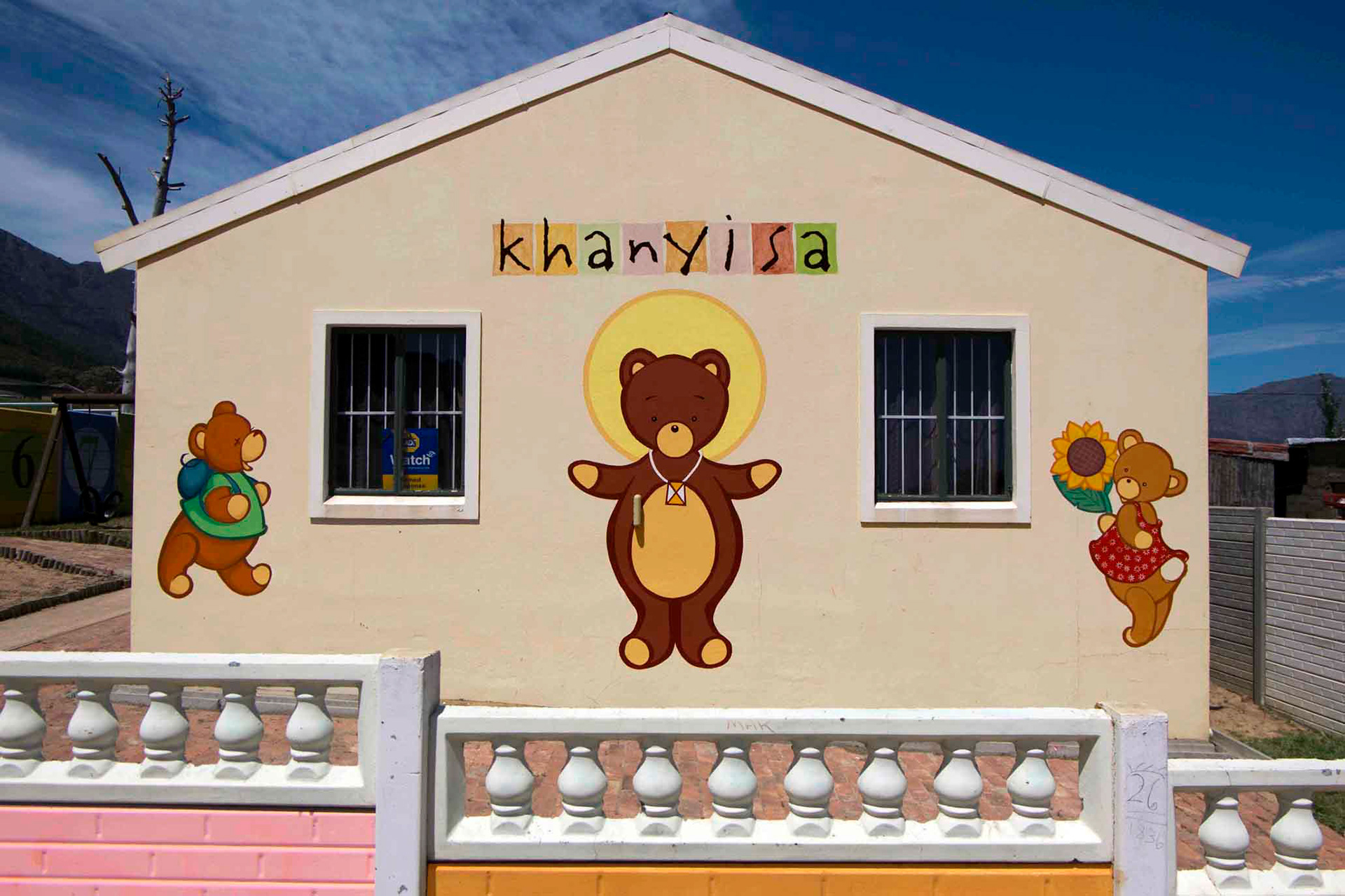 KHANYISA-crèche, 'Khanyisa' is a common name in Xhosa meaning 'light/bright one'. The idea of enlightenment was incorporated in the main teddy bear's head-dress, PVA on plaster, Langrug, Franschhoek, South-Africa.