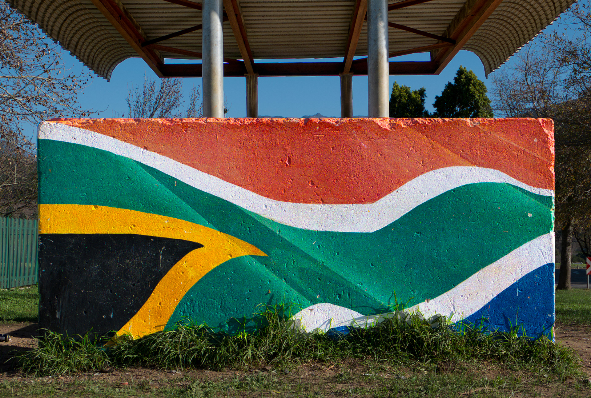 BUS STOP, a commision by the Municipality of Stellenbosch depicting enlarged fragments of the South-African national flag, Groendal Township, Franschhoek, South-Africa, PVA-paint on plaster.