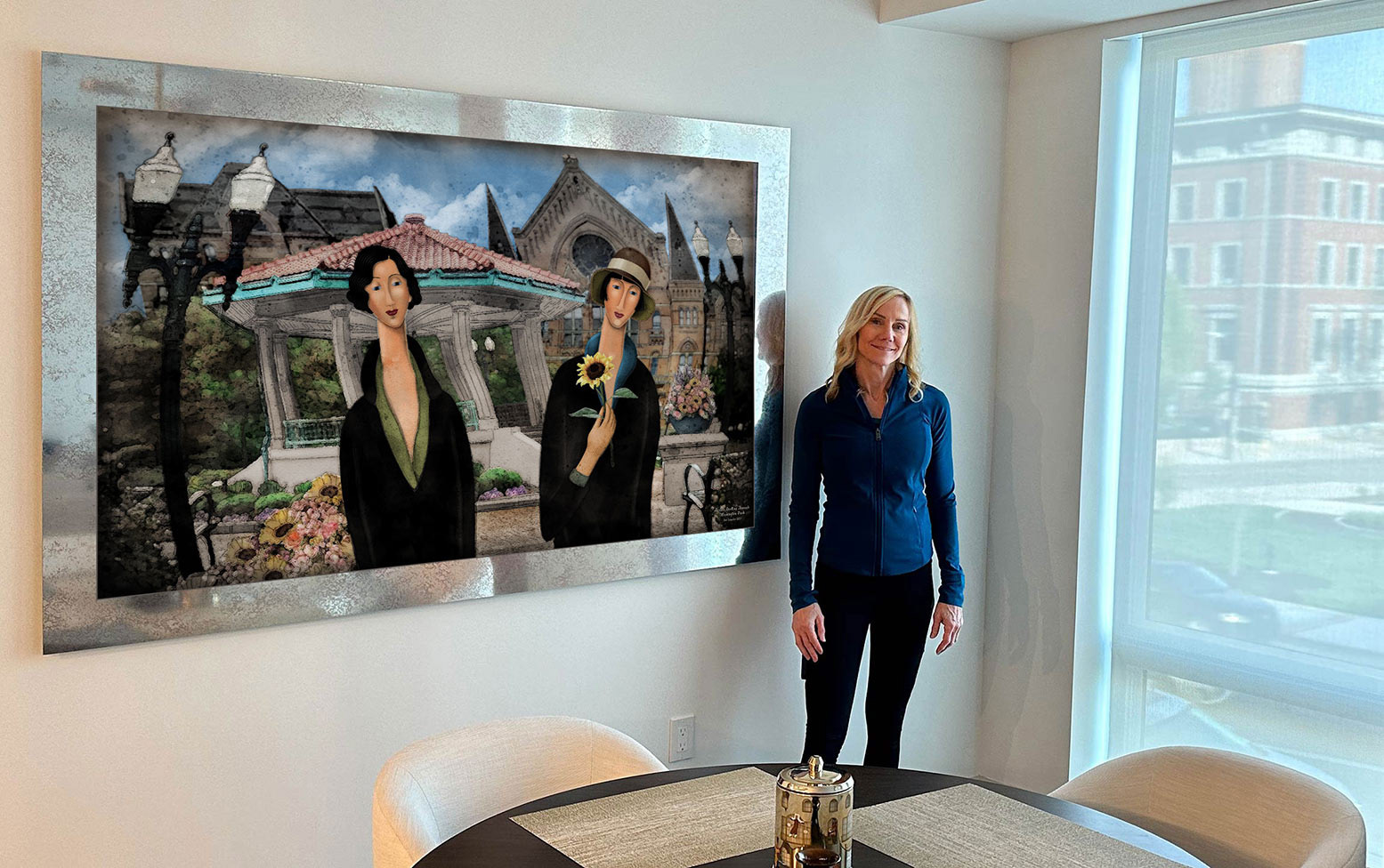 Carol after hanging her print "Sisters strolling through Washington Park" on mirrored metal