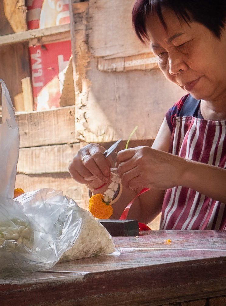 Assembling flower garlands for the flower market @ Khlong Toei Slum, Bangkok, Thailand