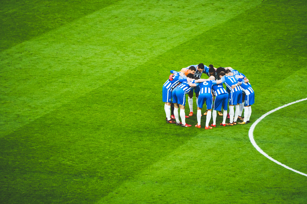 Brighton players huddle before taking on Liverpool at The Amex