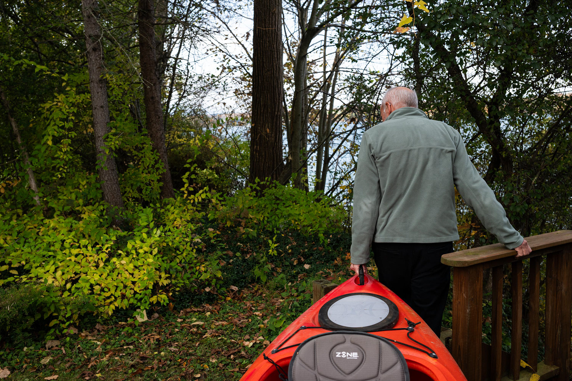 Charlie Driscoll carries his kayak down to the dock on Friday, Oct. 24, 2025, in Skaneateles, N.Y. Driscoll and his wife often kayak on the lake, reflecting a deep personal connection shared by many residents. 
