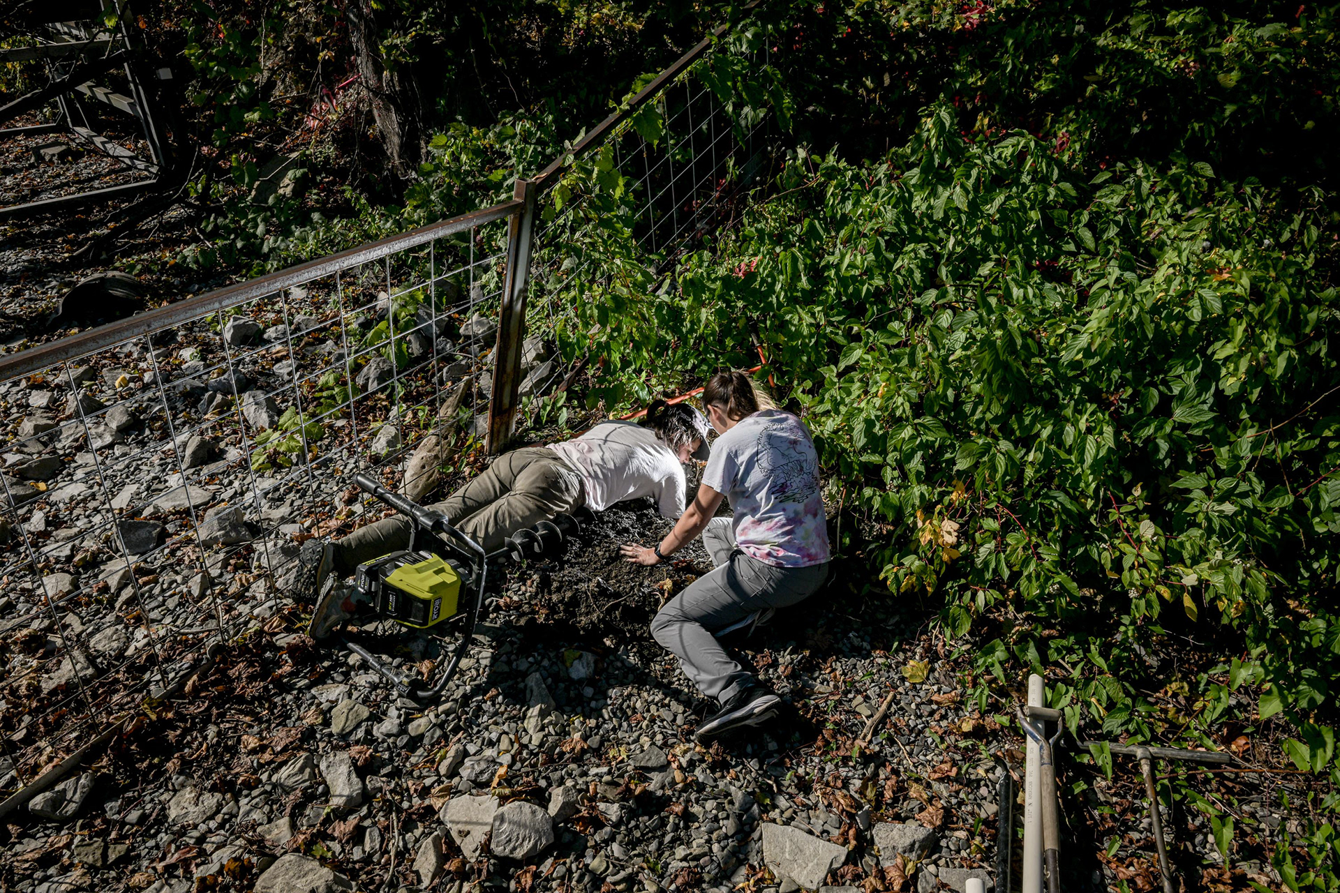 Assistant Professor at the Department of Environmental Resources Engineering at SUNY College of Environmental Science and Forestry, Christine Georgakakos, and Dr. Dominique Dermernio use a hand auger and hand-dig the well at a resident's house on Monday, Oct. 6, 2025, in Skaneatlas, NY. A well was dug several feet away from the shore and the septic tank. The researchers then tested the content in the groundwater. 