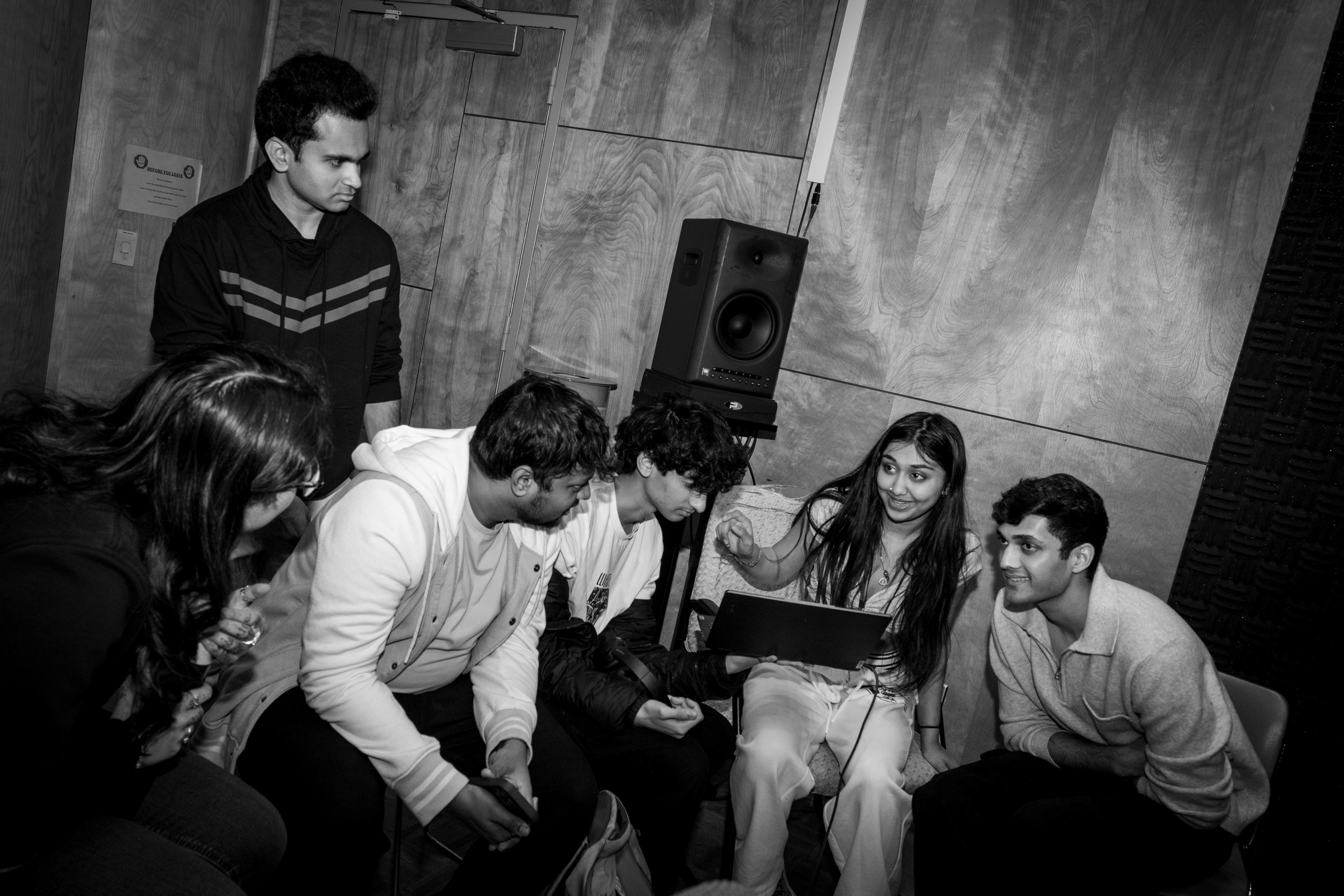 Sahana and members of Desi Performances gather at a music studio to record a Bollywood song, singing in their respective languages and blending different styles as they prepare for the International Festival at Syracuse University.