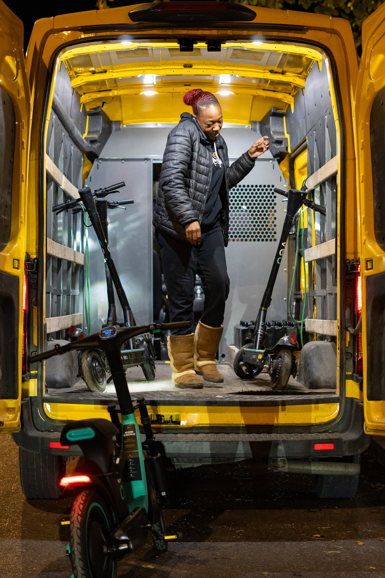 An employee of Veo rideshare company drops off electric scooters in the Marshall St neighborhood of Syracuse, NY near Syracuse University after recharging them. This work is physically intensive and often occurs at night. Veo electric scooter is getting popular in the city of Syracuse, yet not many people knows it's being recharged and distributed