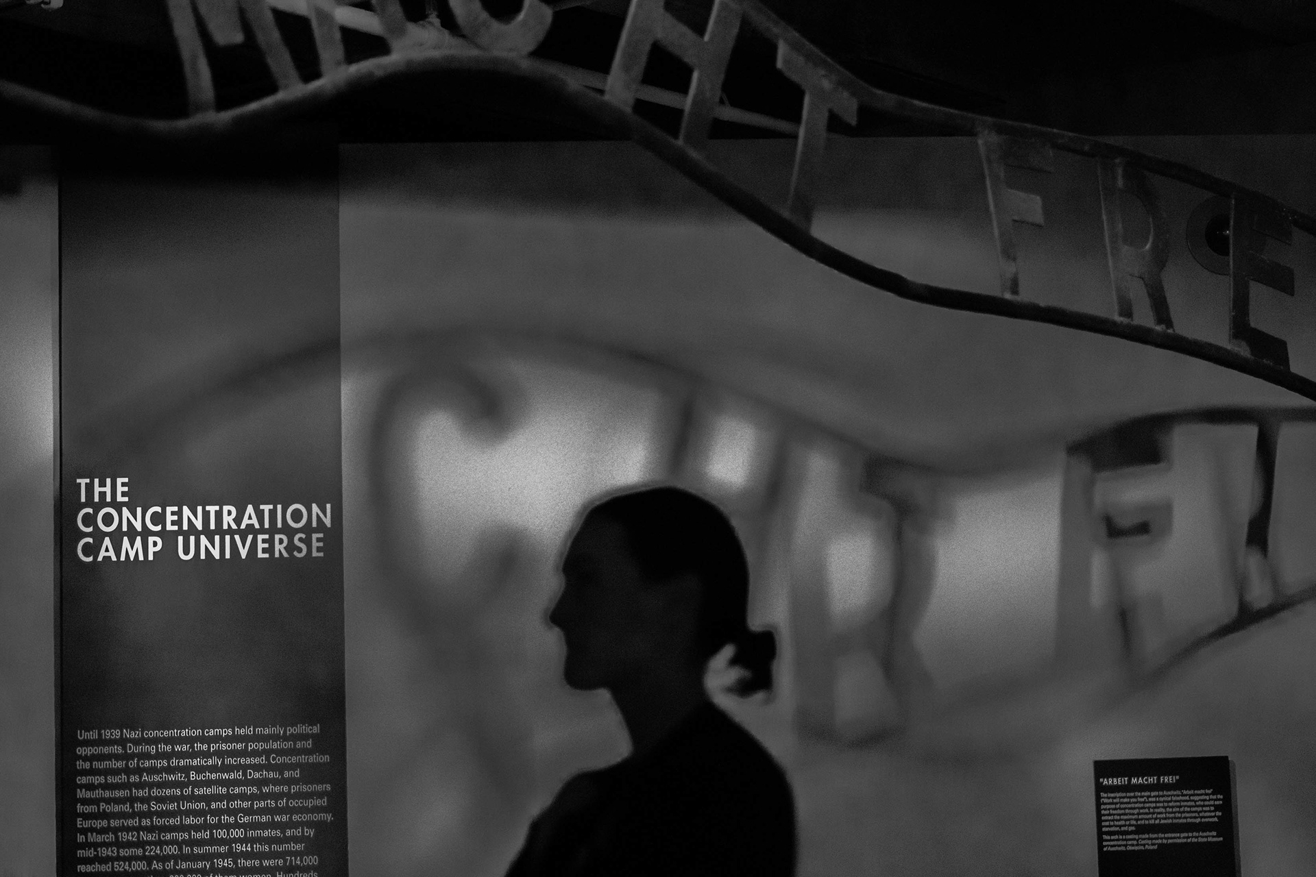 A visitor at the Holocaust Memorial Museum in Washington, D.C. reads through the Concentration Camp Universe museum label, a reminder of humanity's darkest period.